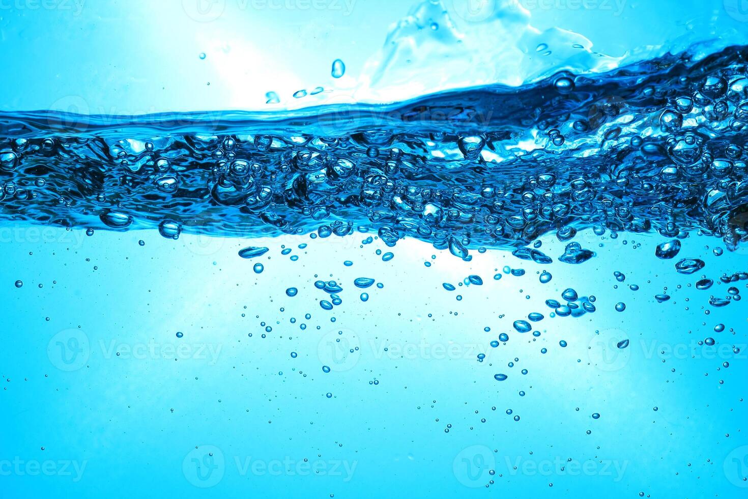 Fresh Water With Underwater Bubbles Texture on a Blue Background Close-up Abstract Liquid Bubbles Aqua Design Wallpaper photo