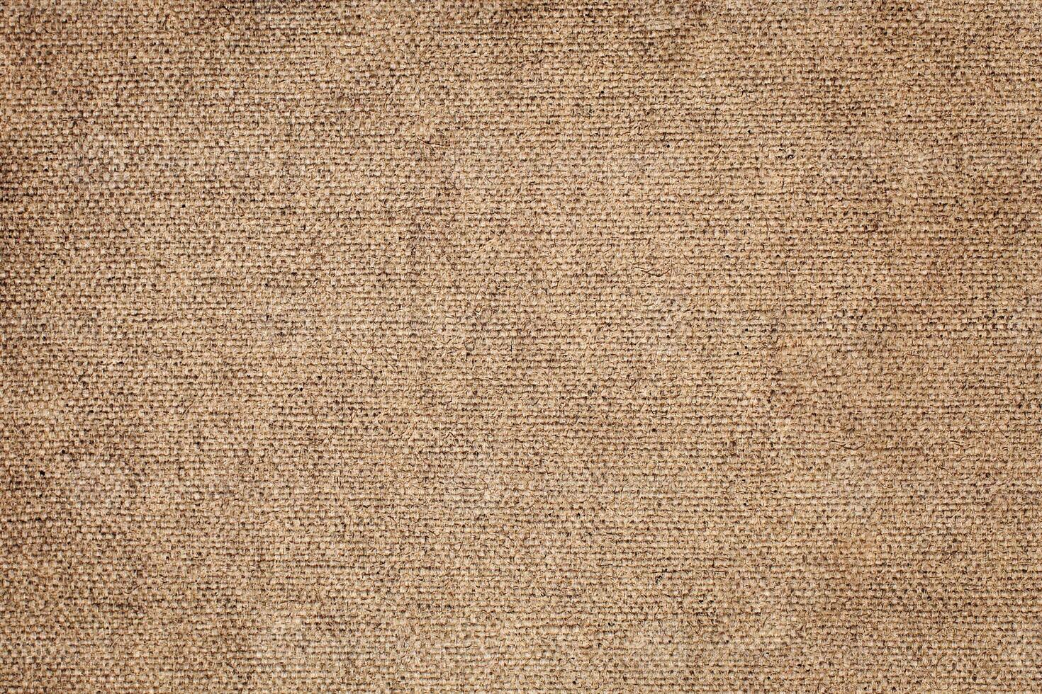 Natural Linen Material Textile Canvas Fabric Texture Background Close-up Detail of Fabric Natural Color Hemp Material Pattern Design Wallpaper. Can be Used as Background or For Graphic Design photo