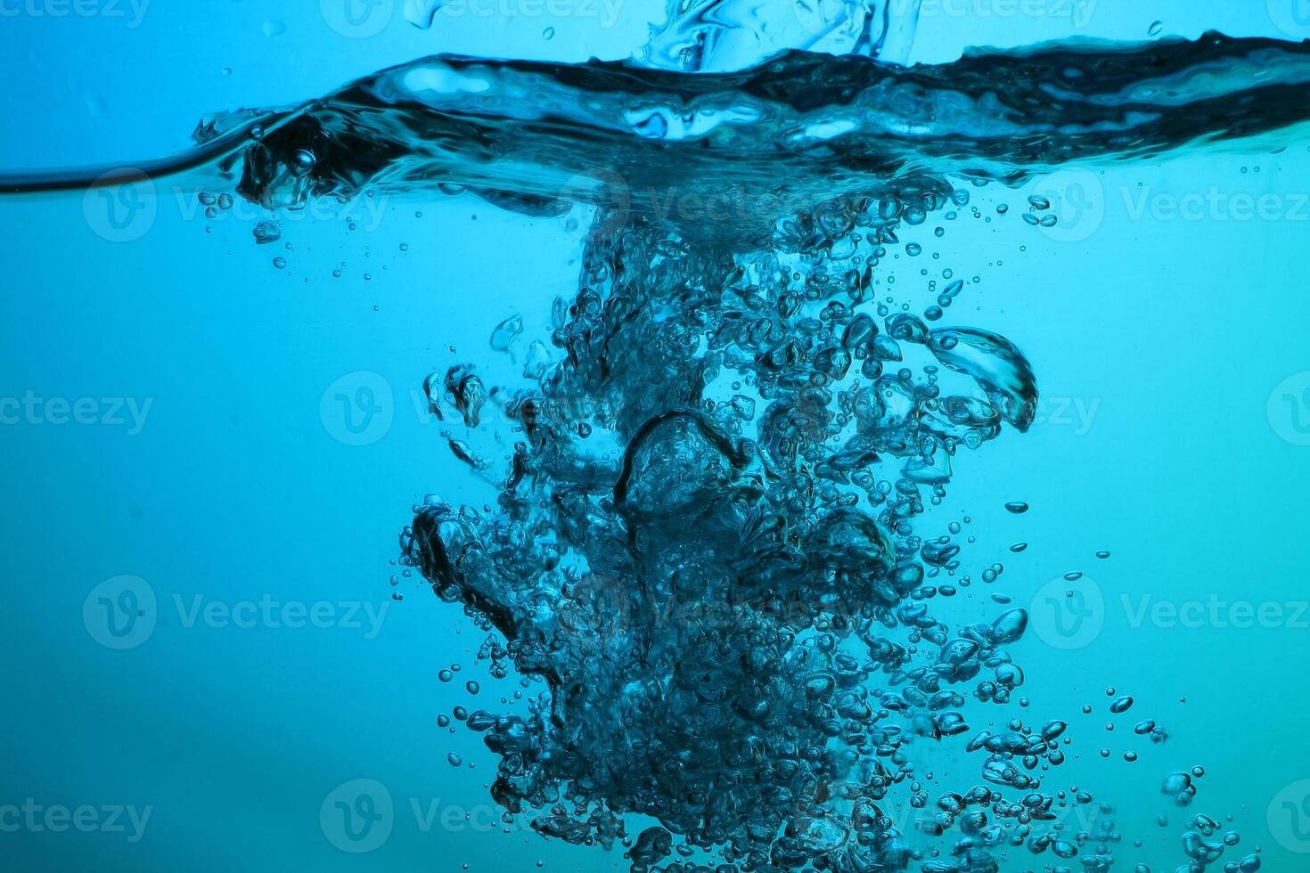Fresh Water With Underwater Bubbles Texture on a Blue Background Close-up Abstract Liquid Bubbles Aqua Design Wallpaper photo