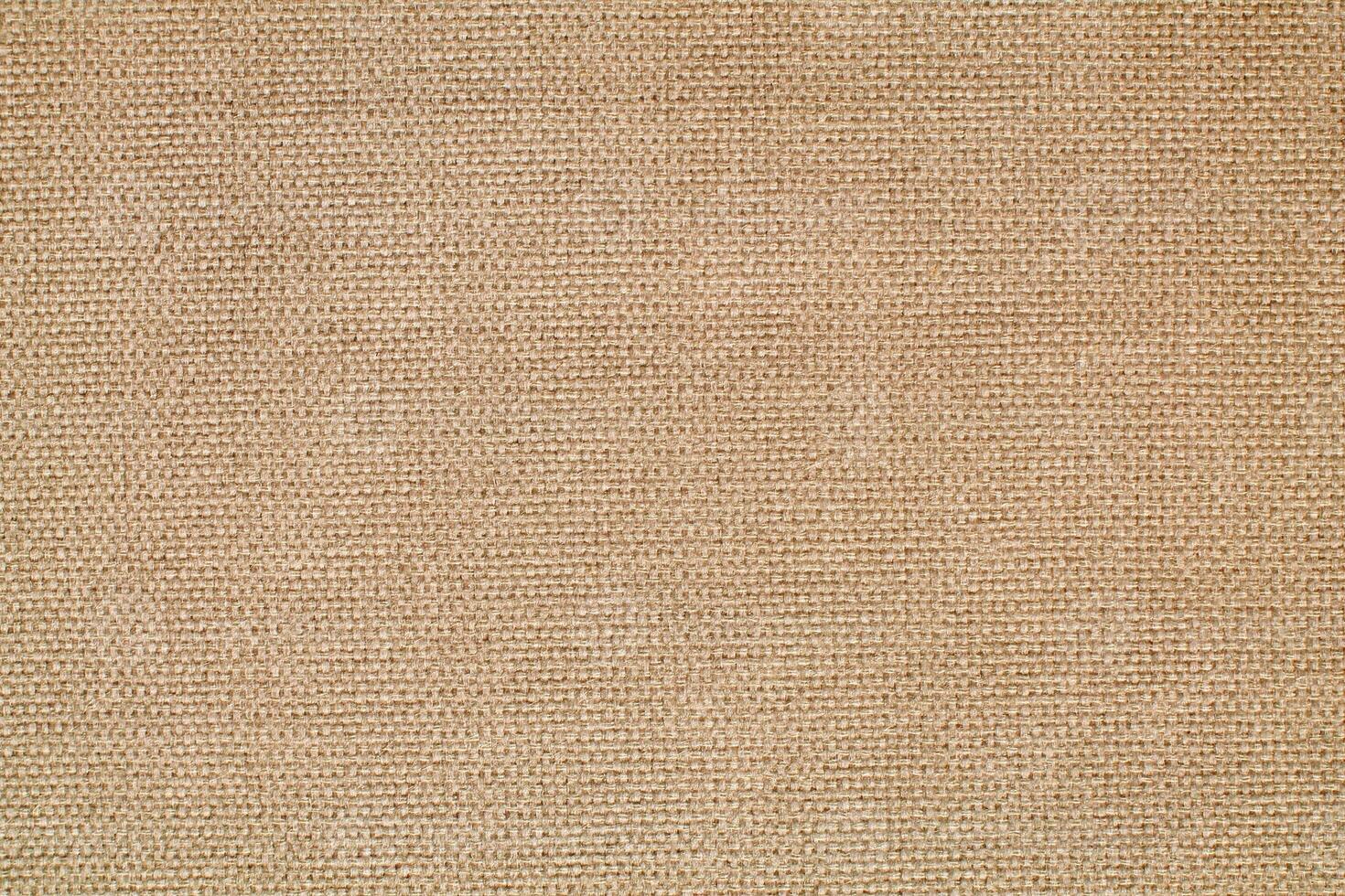 Natural Linen Material Textile Canvas Fabric Texture Background Close-up Detail of Fabric Natural Color Hemp Material Pattern Design Wallpaper. Can be Used as Background or For Graphic Design photo