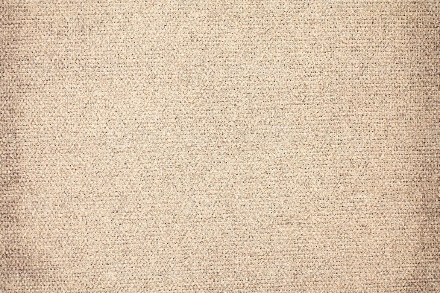 Natural Linen Material Textile Canvas Fabric Texture Background Close-up Detail of Fabric Natural Color Hemp Material Pattern Design Wallpaper. Can be Used as Background or For Graphic Design photo