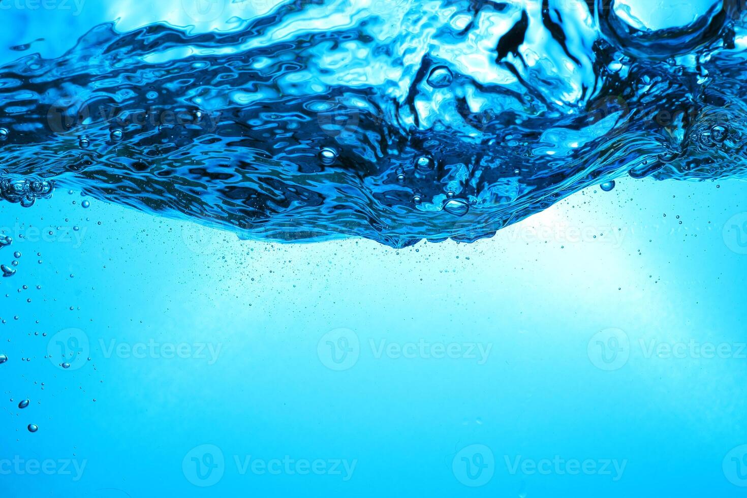 Fresh Water With Underwater Bubbles Texture on a Blue Background Close-up Abstract Liquid Bubbles Aqua Design Wallpaper photo