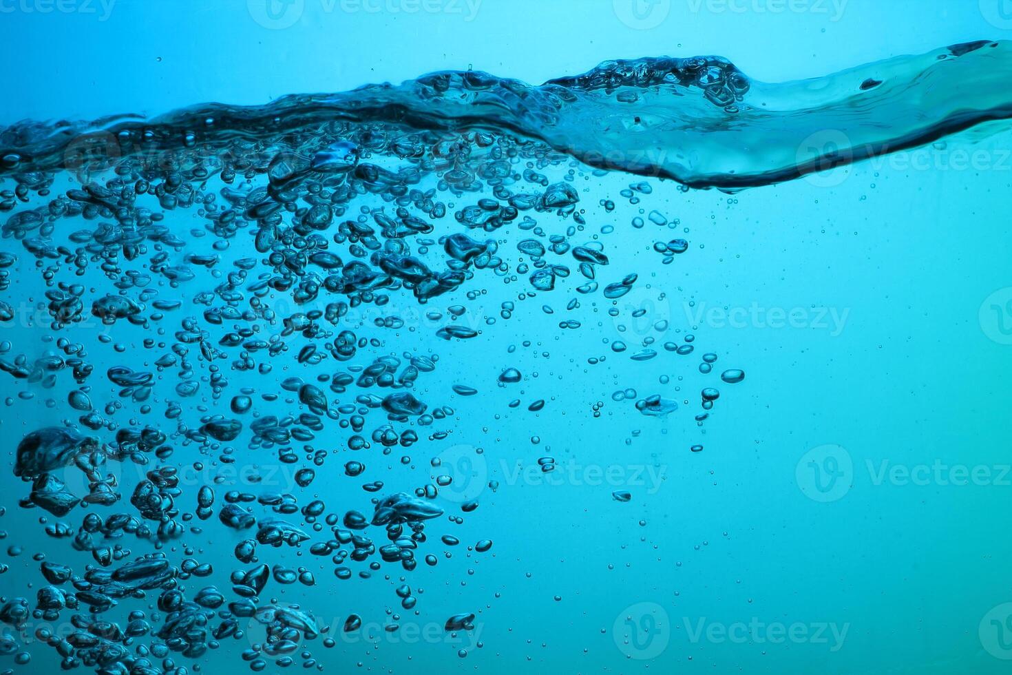 Fresh Water With Underwater Bubbles Texture on a Blue Background Close-up Abstract Liquid Bubbles Aqua Design Wallpaper photo
