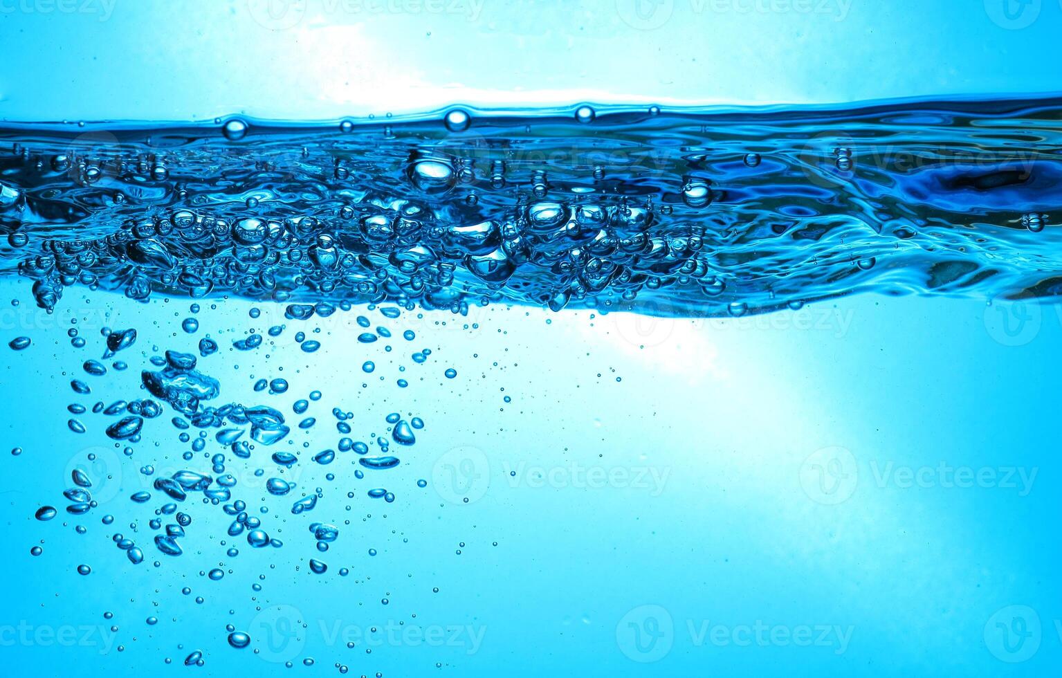 Fresh Water With Underwater Bubbles Texture on a Blue Background Close-up Abstract Liquid Bubbles Aqua Design Wallpaper photo