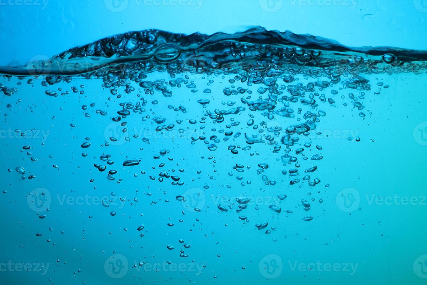 Fresh Water With Underwater Bubbles Texture on a Blue Background Close-up Abstract Liquid Bubbles Aqua Design Wallpaper photo