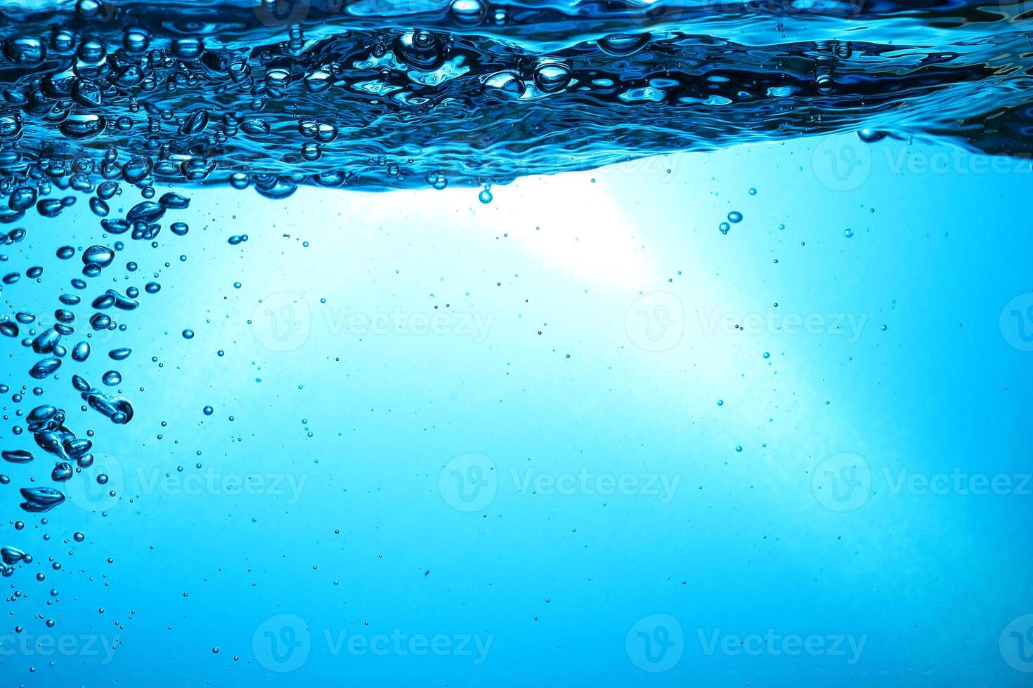 Fresh Water With Underwater Bubbles Texture on a Blue Background Close-up Abstract Liquid Bubbles Aqua Design Wallpaper photo
