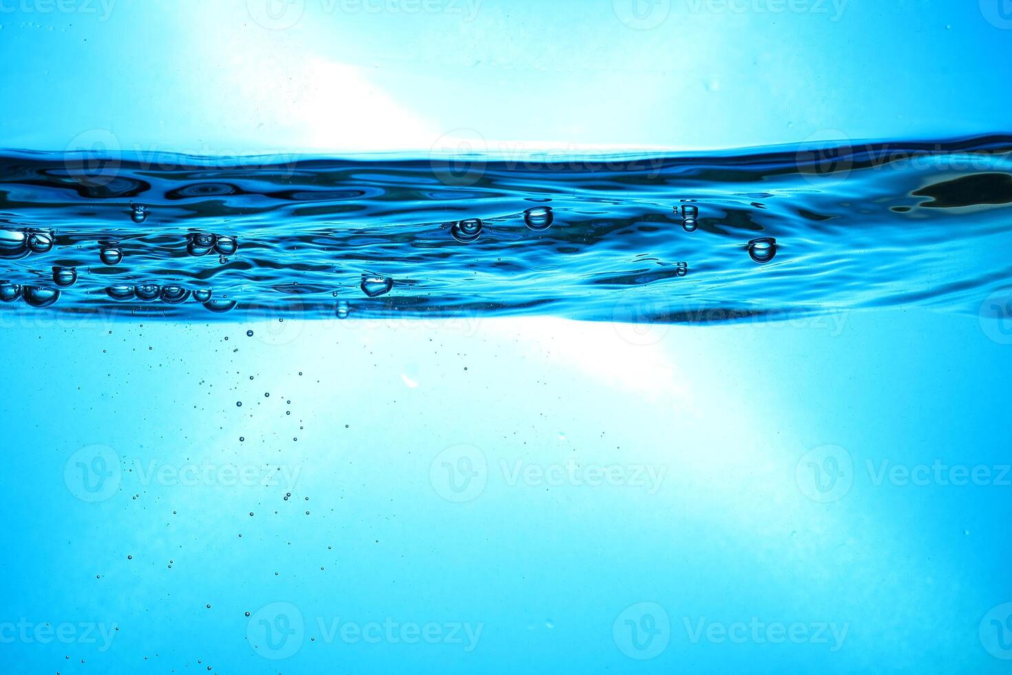 Fresh Water With Underwater Bubbles Texture on a Blue Background Close-up Abstract Liquid Bubbles Aqua Design Wallpaper photo