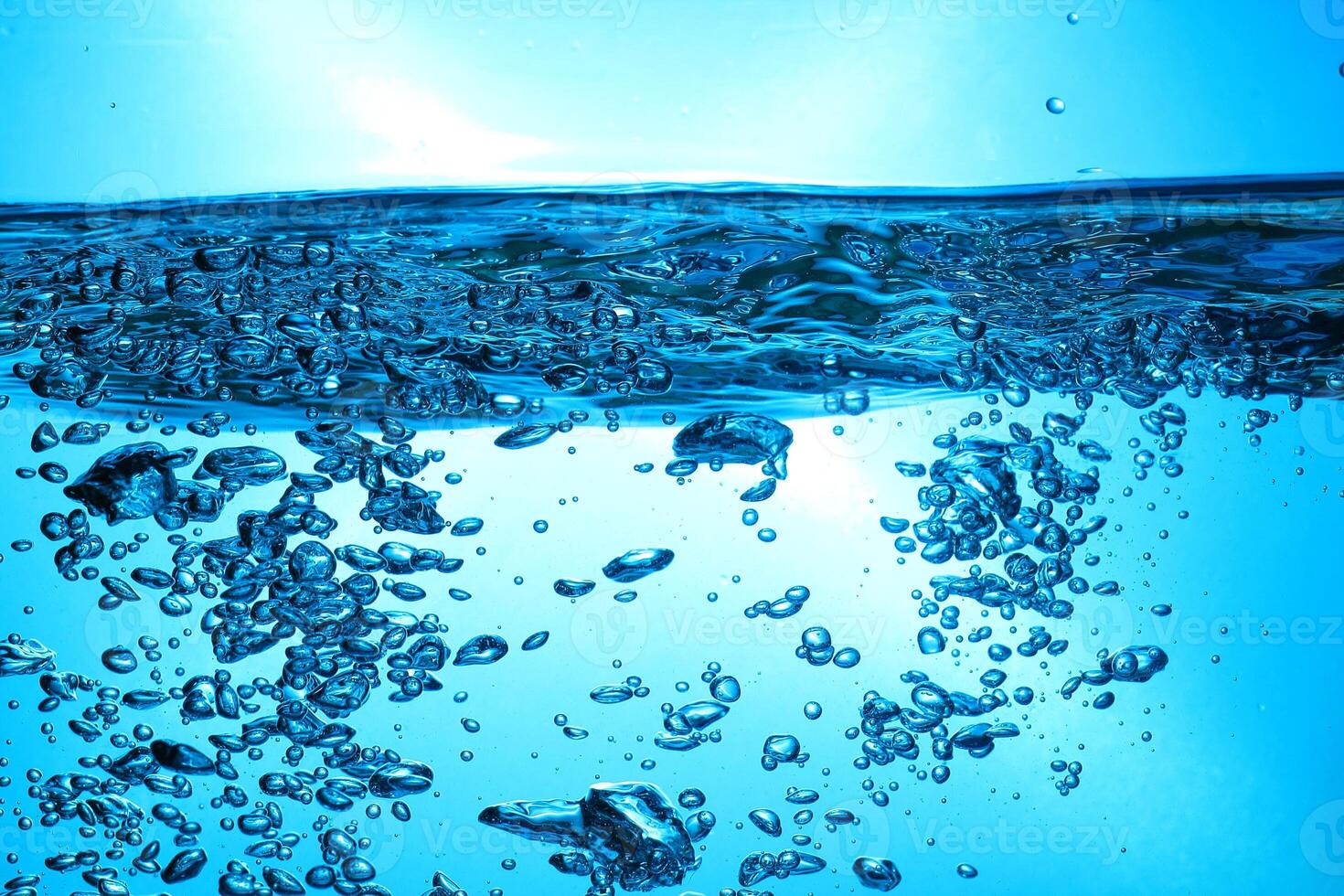 Fresh Water With Underwater Bubbles Texture on a Blue Background Close-up Abstract Liquid Bubbles Aqua Design Wallpaper photo