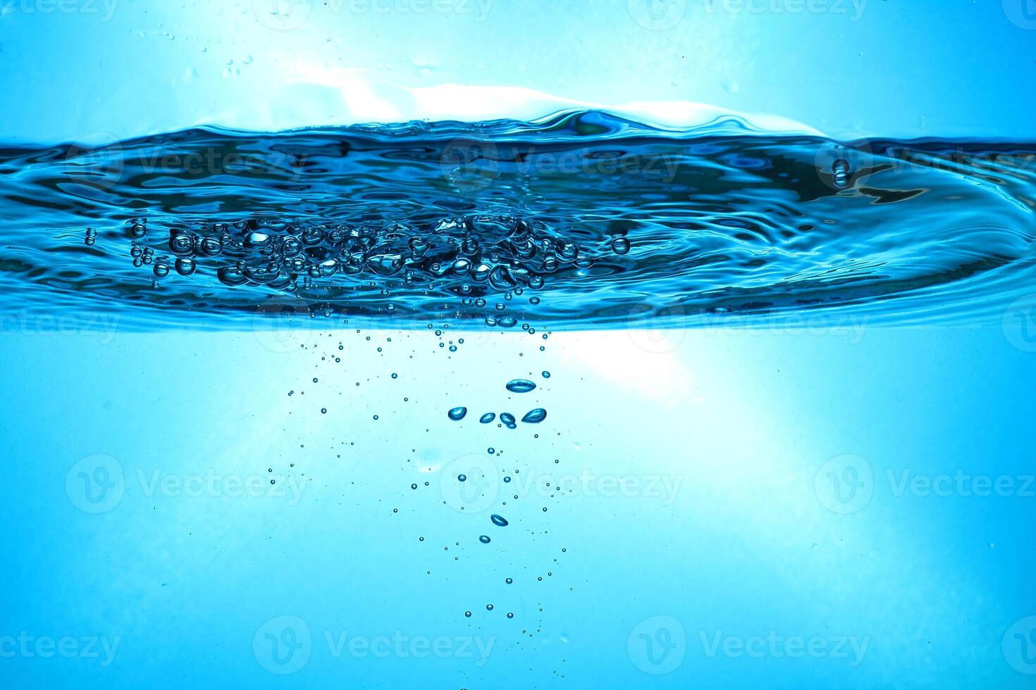 Fresh Water With Underwater Bubbles Texture on a Blue Background Close-up Abstract Liquid Bubbles Aqua Design Wallpaper photo