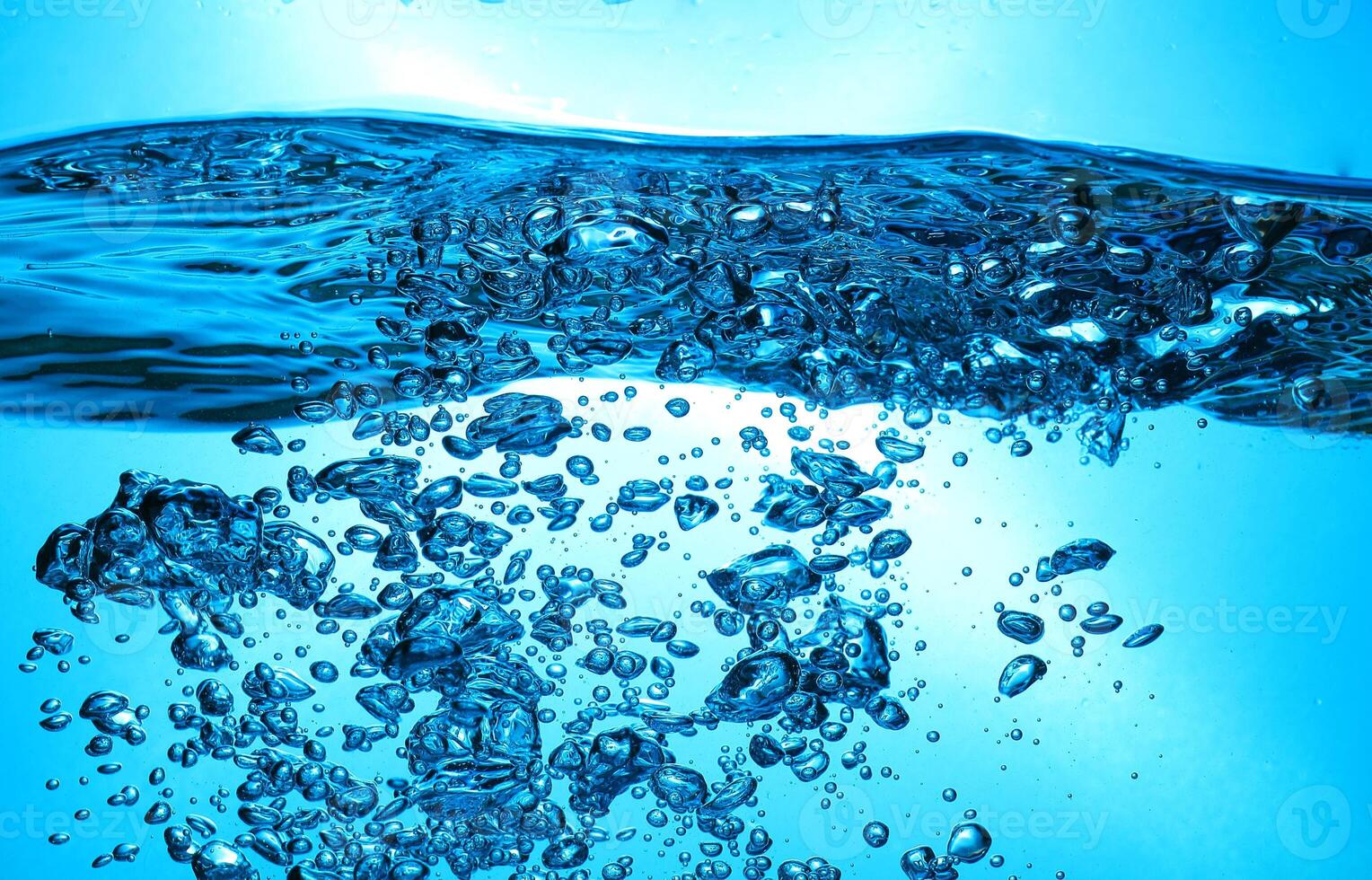 Fresh Water With Underwater Bubbles Texture on a Blue Background Close-up Abstract Liquid Bubbles Aqua Design Wallpaper photo