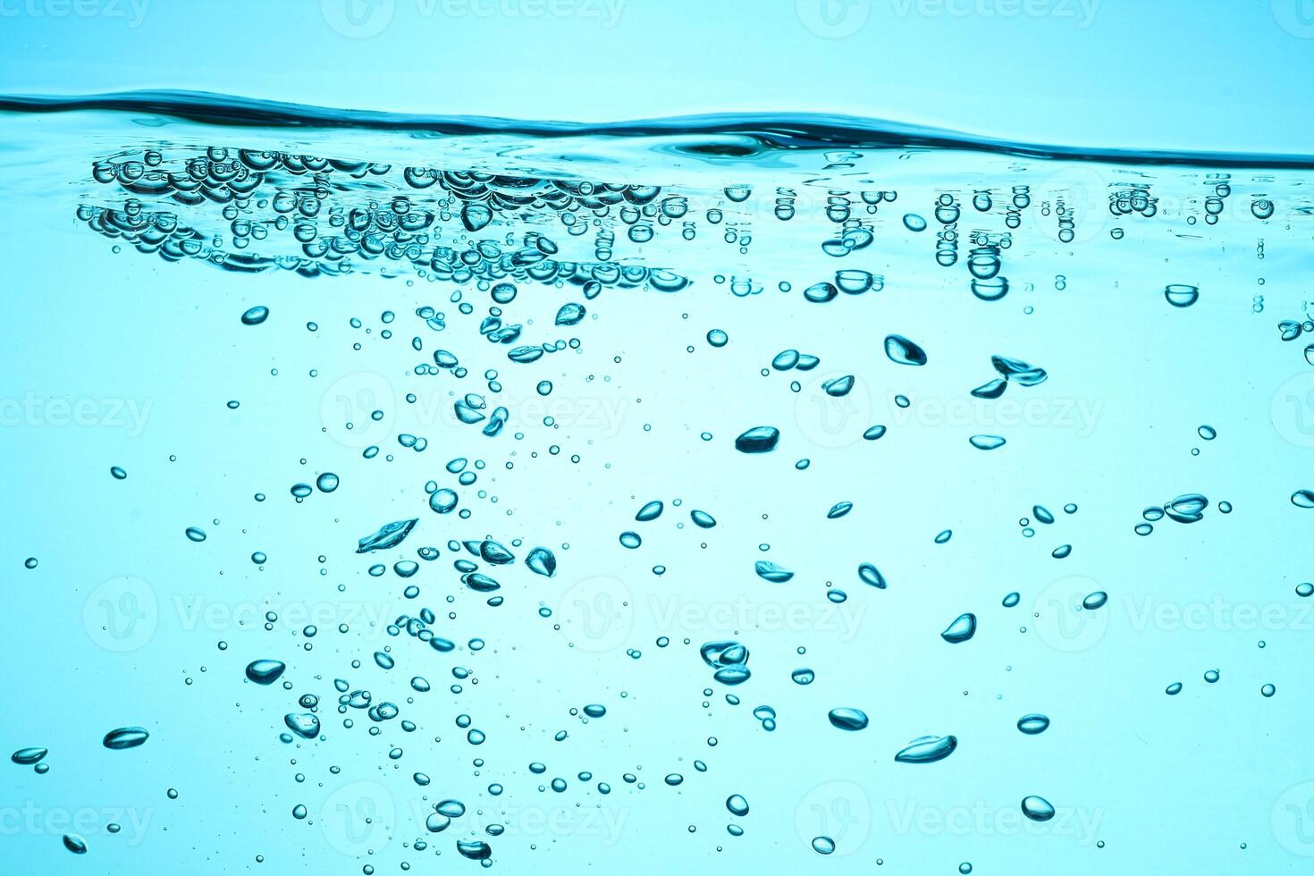 Fresh Water With Underwater Bubbles Texture on a Blue Background Close-up Abstract Liquid Bubbles Aqua Design Wallpaper photo