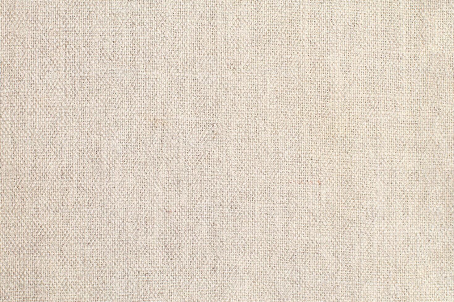 Natural Linen Material Textile Canvas Fabric Texture Background Close-up Detail of Fabric Natural Color Hemp Material Pattern Design Wallpaper. Can be Used as Background or For Graphic Design photo