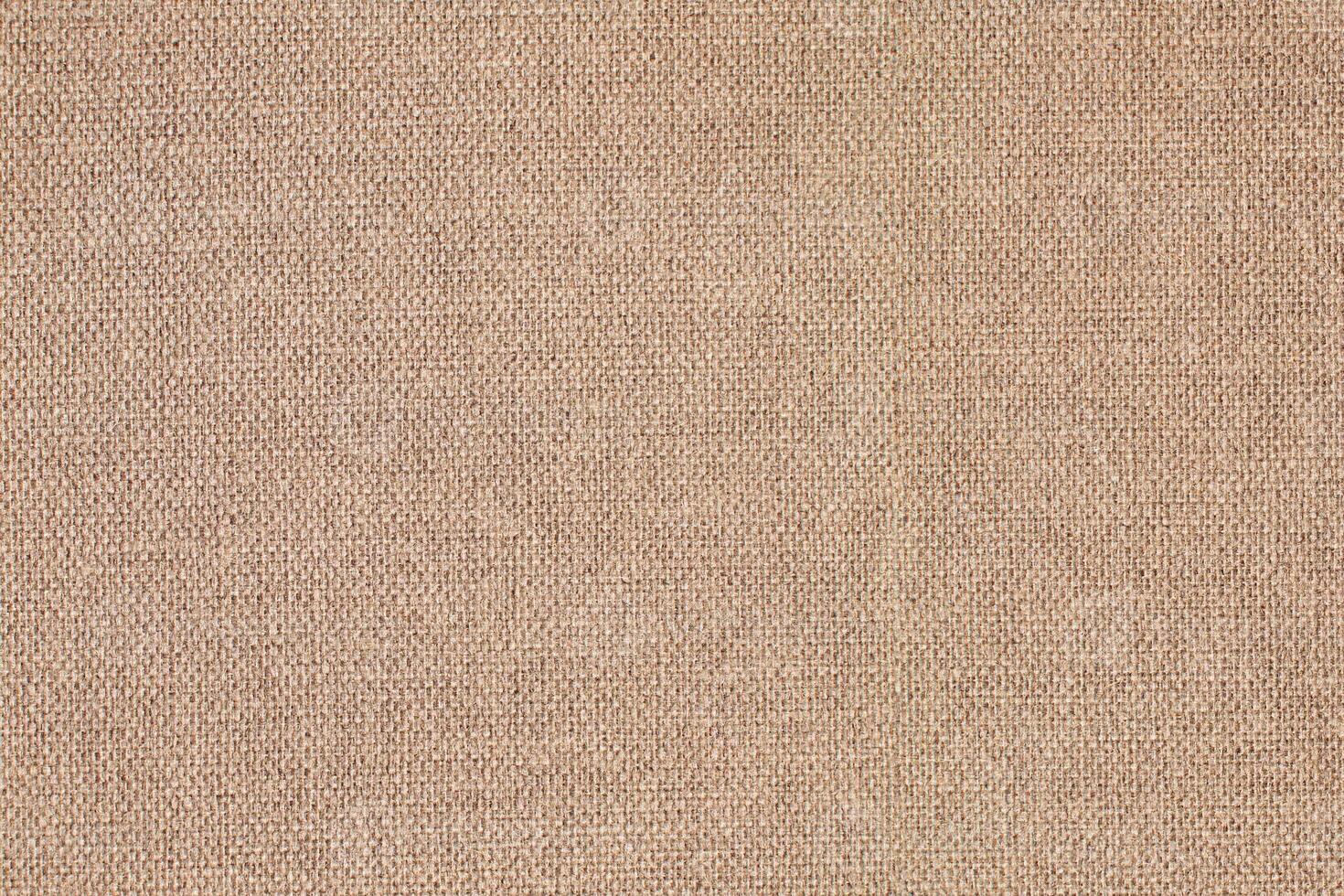 Natural Linen Material Textile Canvas Fabric Texture Background Close-up Detail of Fabric Natural Color Hemp Material Pattern Design Wallpaper. Can be Used as Background or For Graphic Design photo