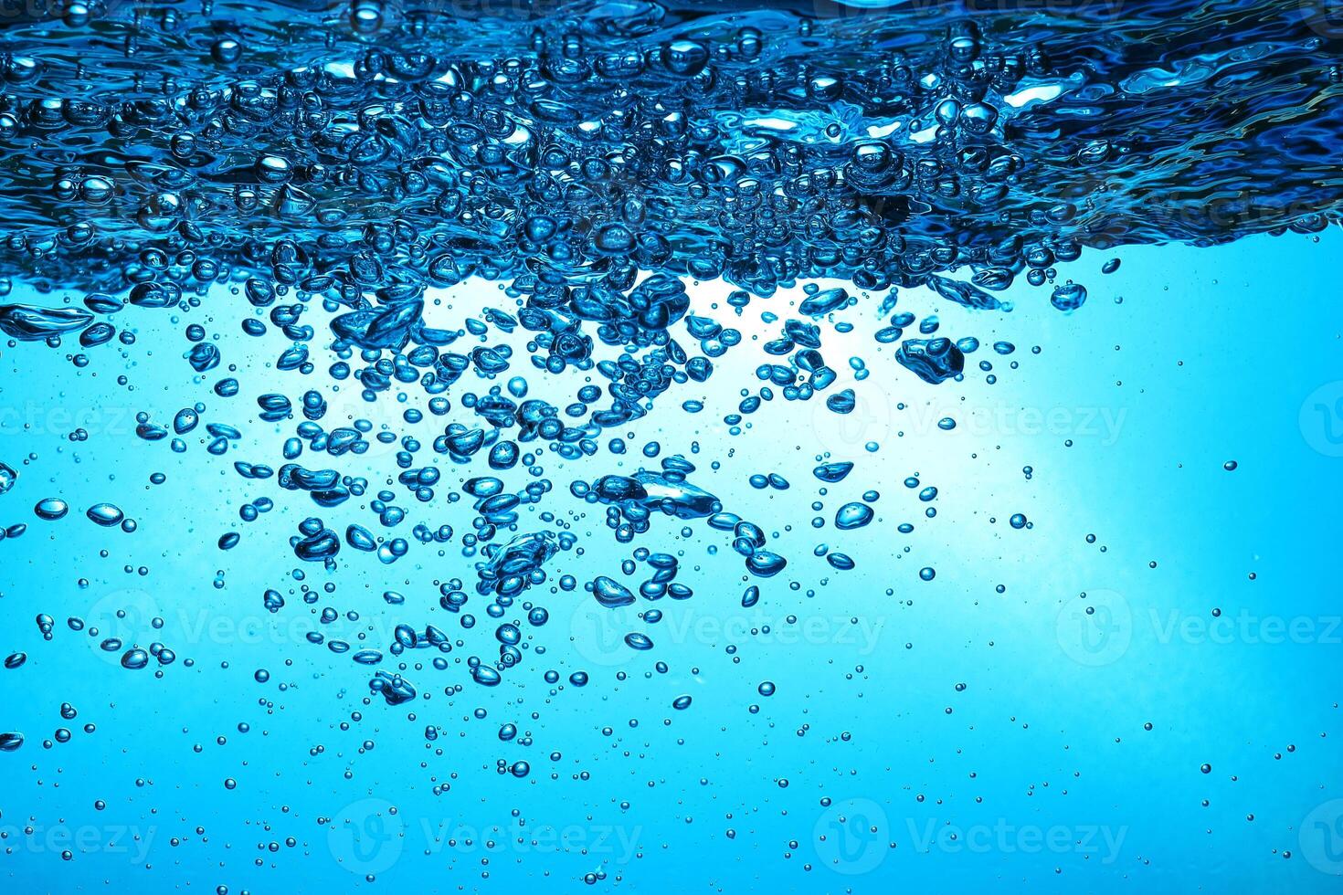 Fresh Water With Underwater Bubbles Texture on a Blue Background Close-up Abstract Liquid Bubbles Aqua Design Wallpaper photo