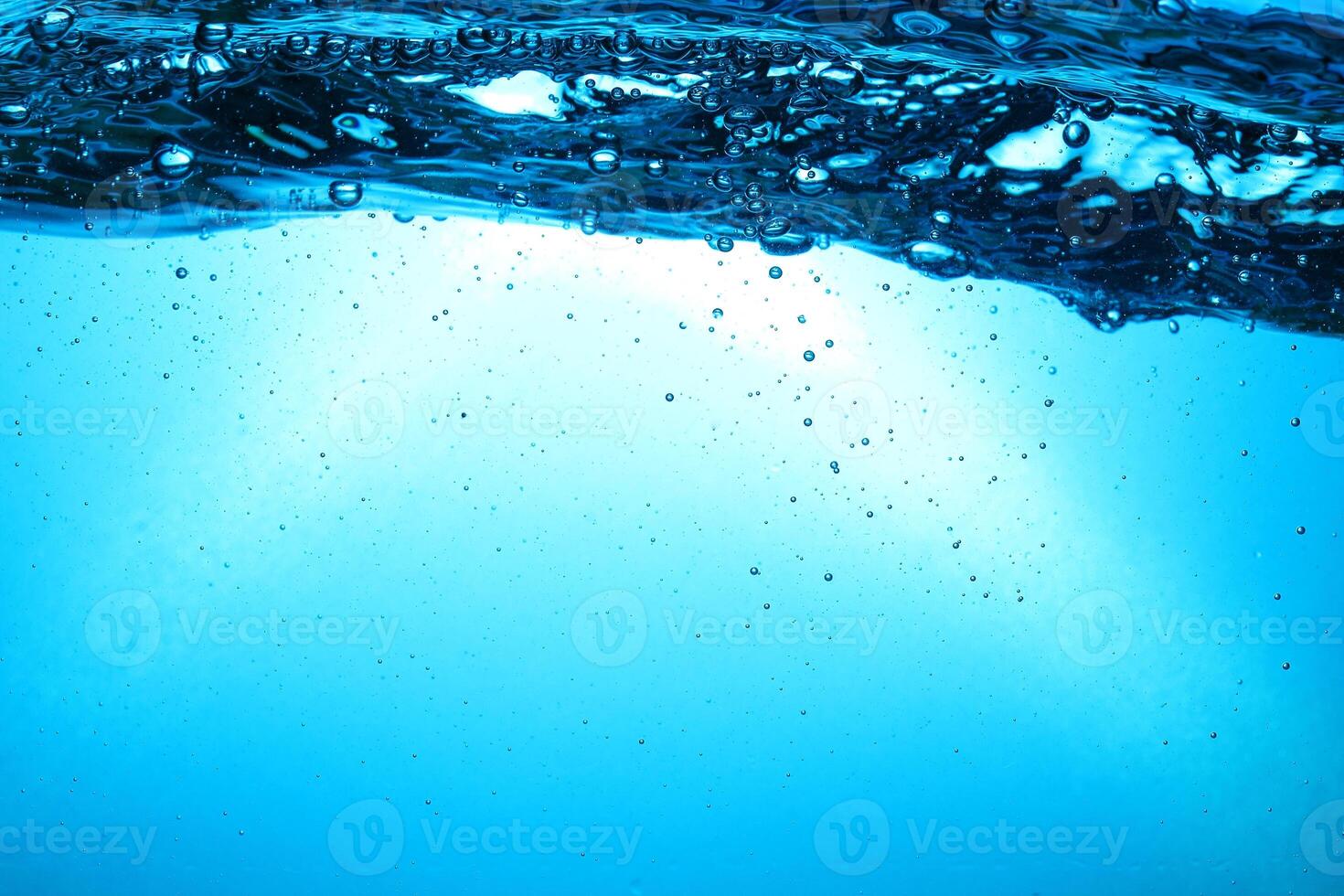 Fresh Water With Underwater Bubbles Texture on a Blue Background Close-up Abstract Liquid Bubbles Aqua Design Wallpaper photo