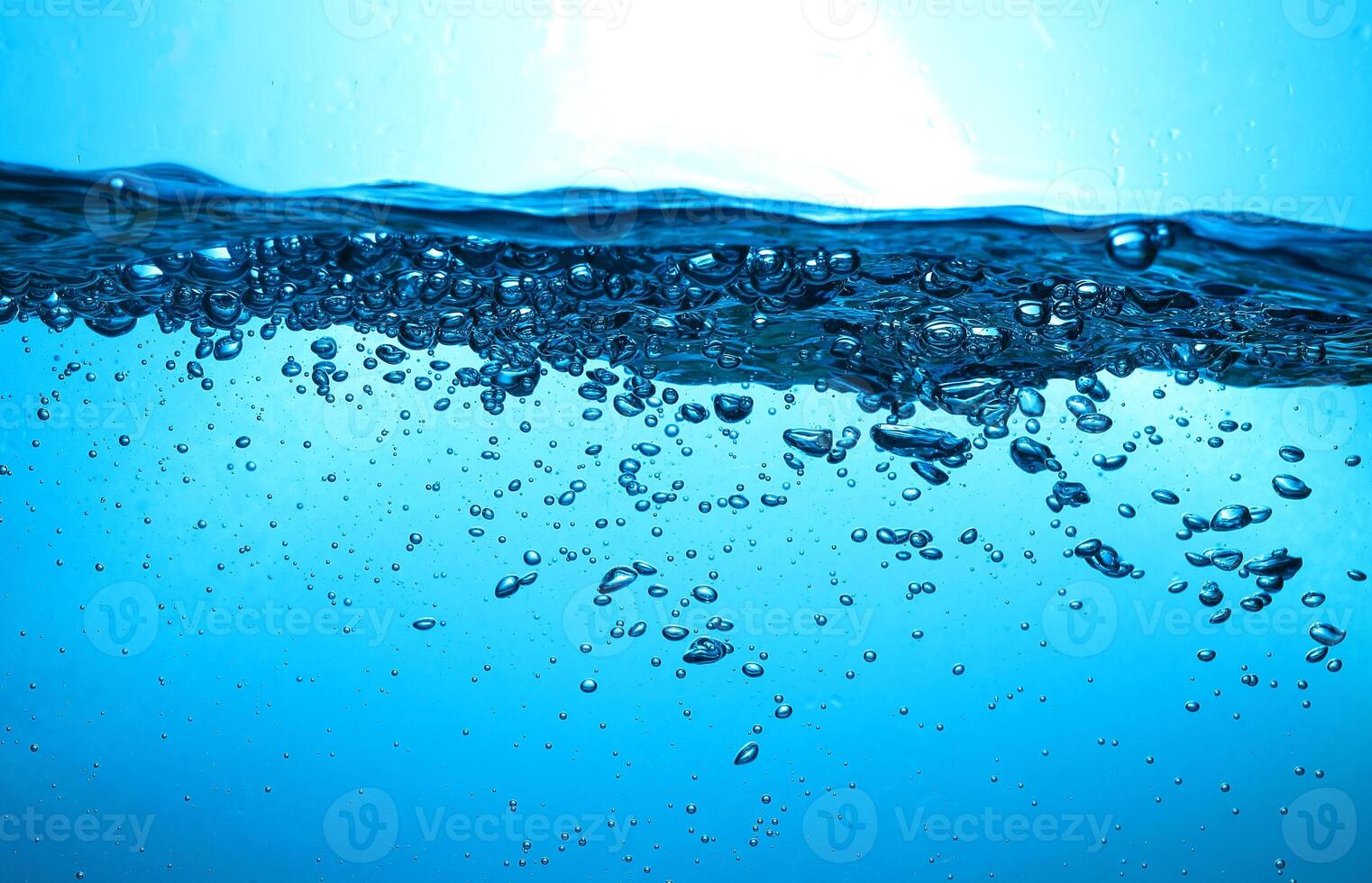 Fresh Water With Underwater Bubbles Texture on a Blue Background Close-up Abstract Liquid Bubbles Aqua Design Wallpaper photo