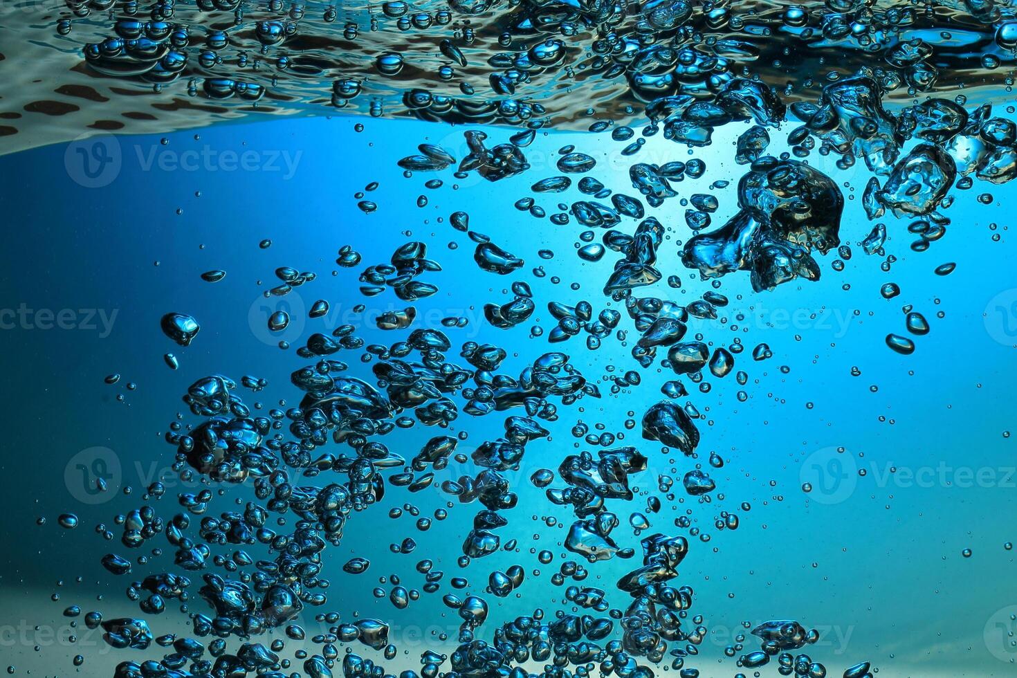 Fresh Water With Underwater Bubbles Texture on a Blue Background Close-up Abstract Liquid Bubbles Aqua Design Wallpaper photo