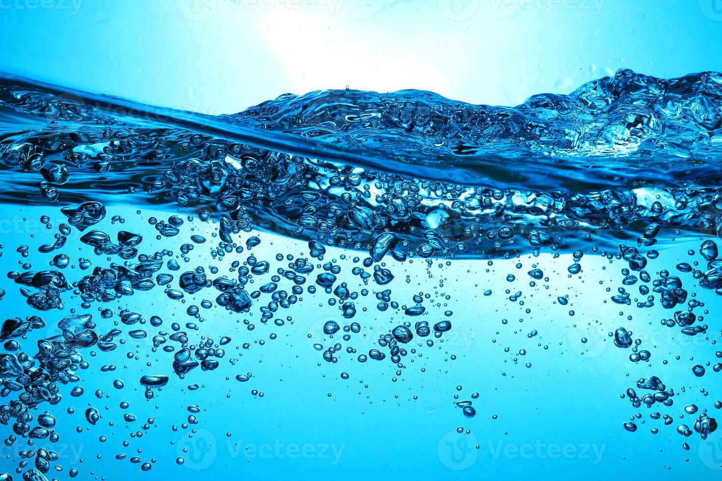 Fresh Water With Underwater Bubbles Texture on a Blue Background Close-up Abstract Liquid Bubbles Aqua Design Wallpaper photo