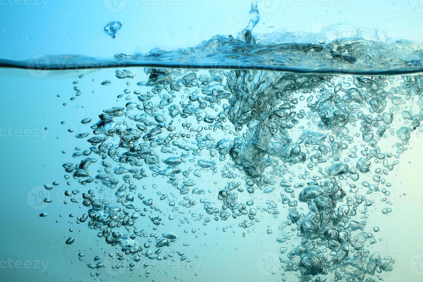 Fresh Water With Underwater Bubbles Texture on a Blue Background Close-up Abstract Liquid Bubbles Aqua Design Wallpaper photo