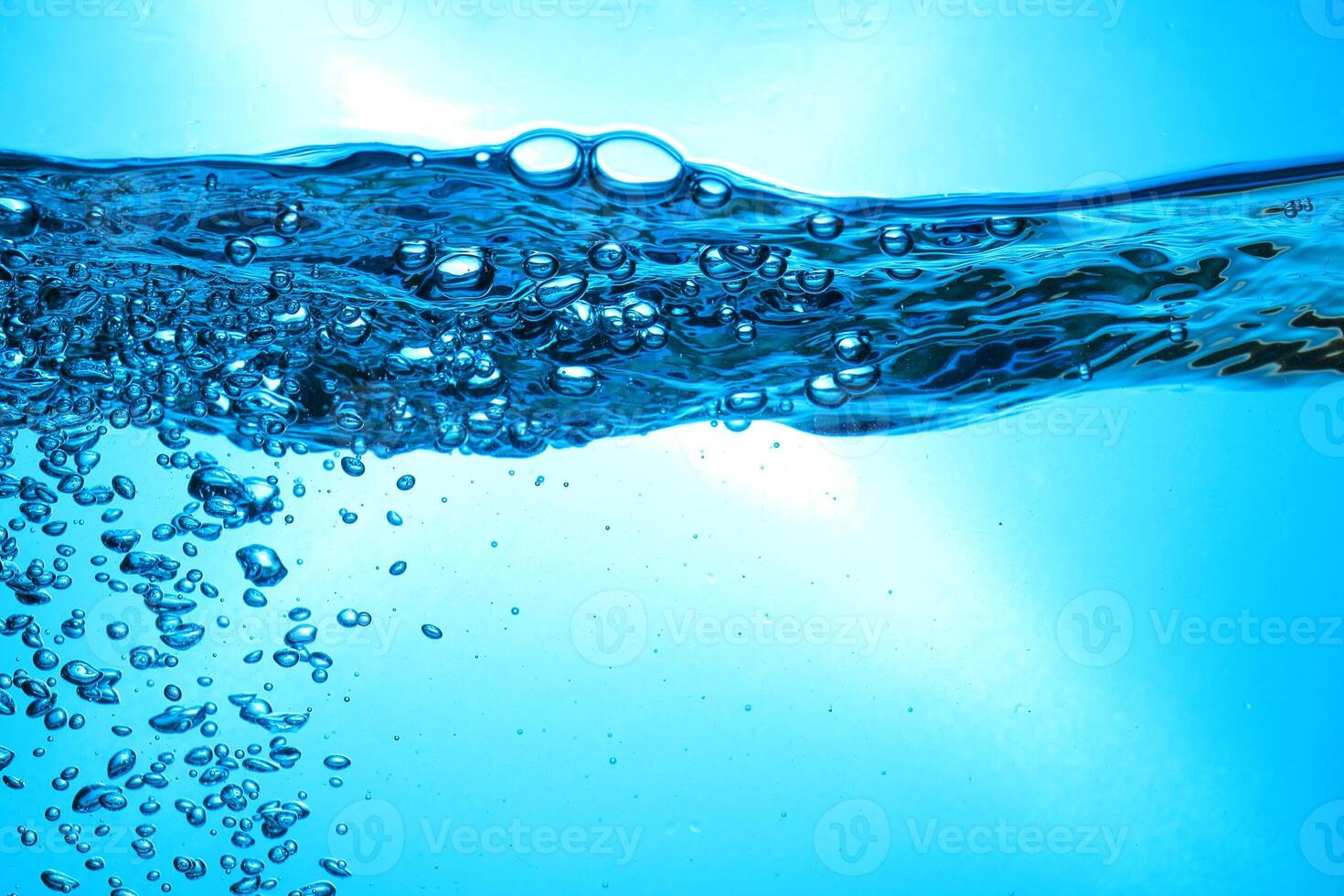 Fresh Water With Underwater Bubbles Texture on a Blue Background Close-up Abstract Liquid Bubbles Aqua Design Wallpaper photo