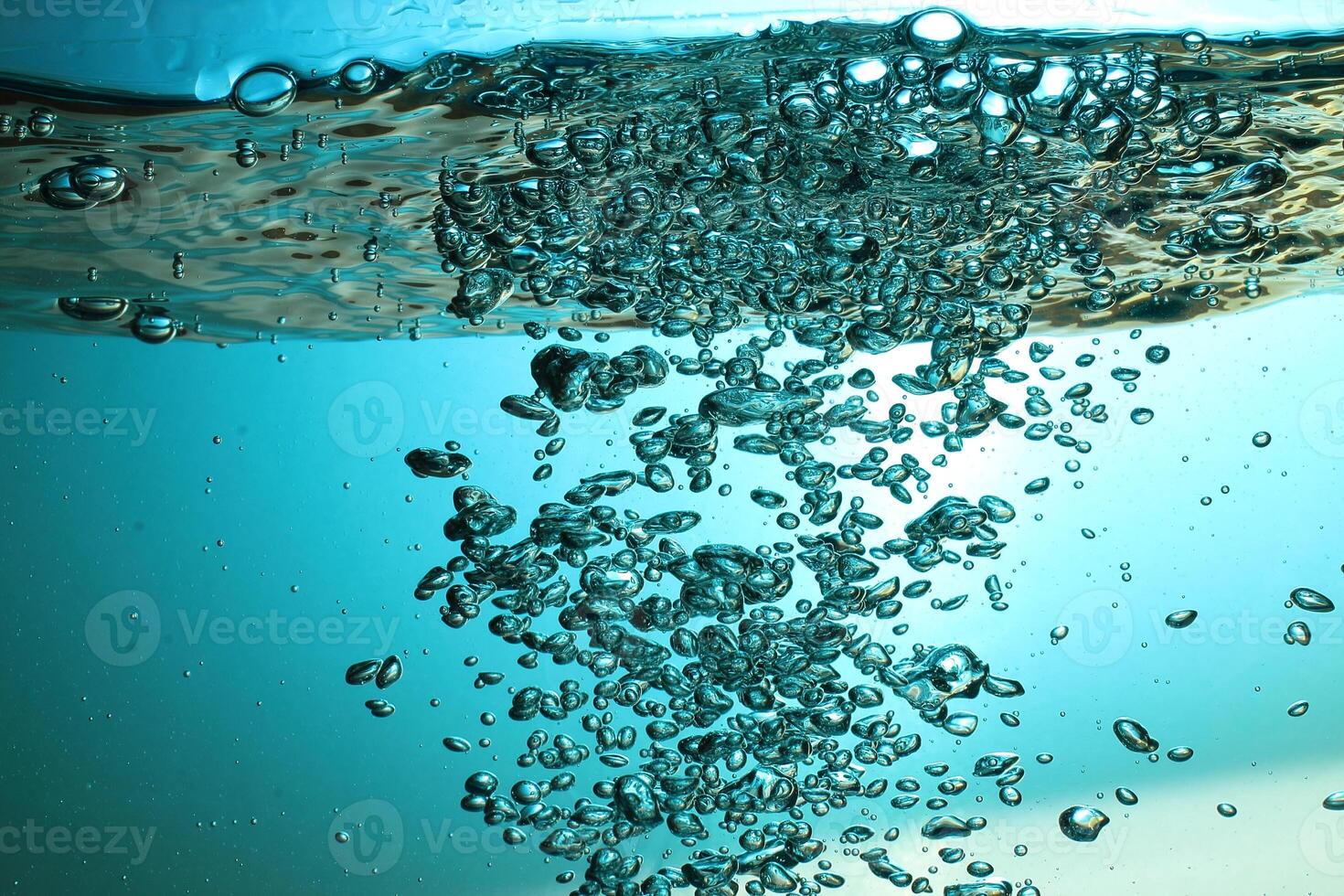 Fresh Water With Underwater Bubbles Texture on a Blue Background Close-up Abstract Liquid Bubbles Aqua Design Wallpaper photo