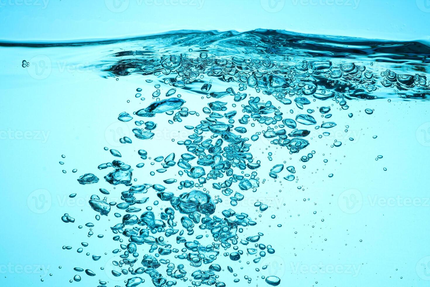 Fresh Water With Underwater Bubbles Texture on a Blue Background Close-up Abstract Liquid Bubbles Aqua Design Wallpaper photo