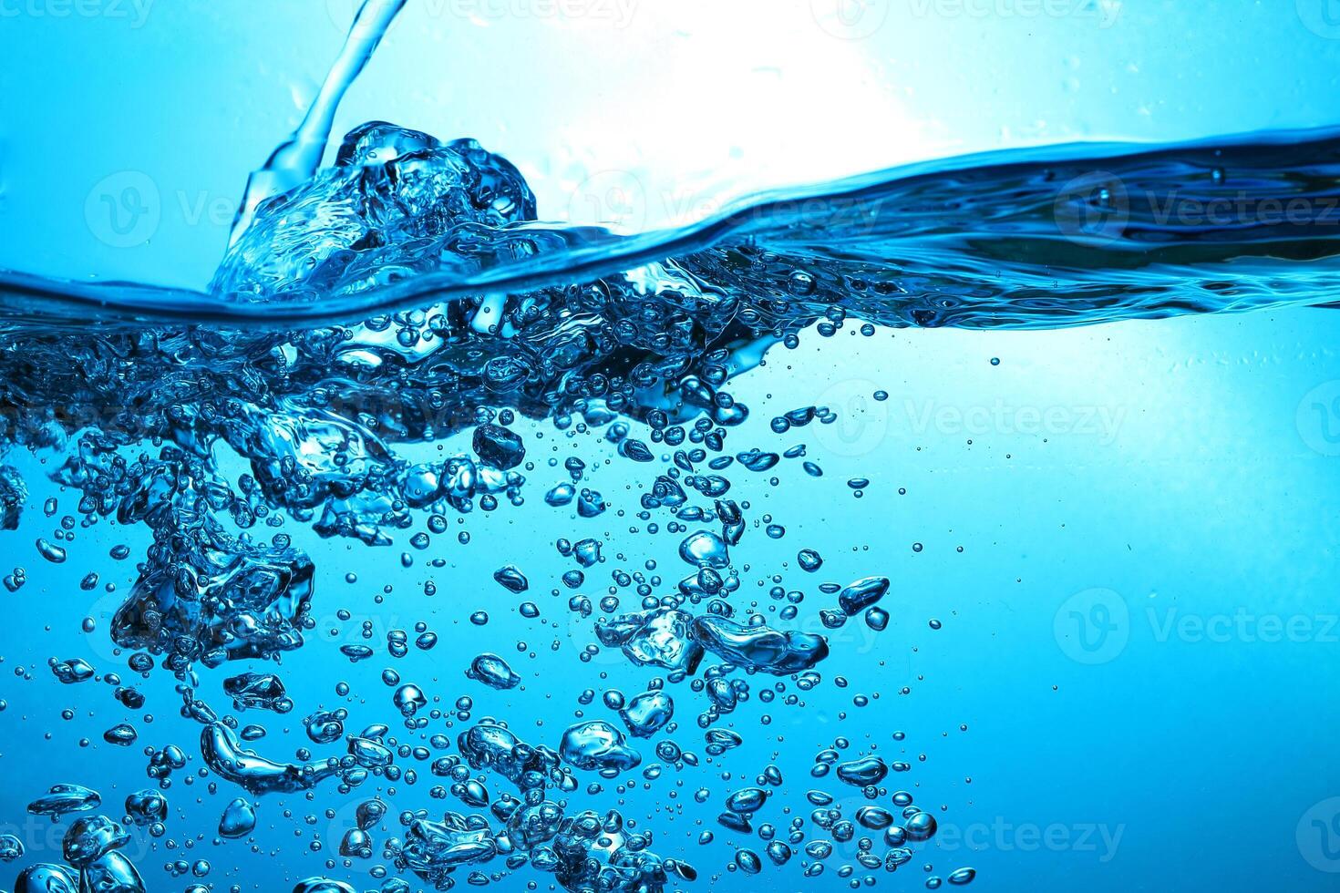 Fresh Water With Underwater Bubbles Texture on a Blue Background Close-up Abstract Liquid Bubbles Aqua Design Wallpaper photo