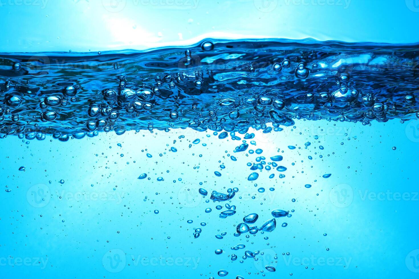 Fresh Water With Underwater Bubbles Texture on a Blue Background Close-up Abstract Liquid Bubbles Aqua Design Wallpaper photo