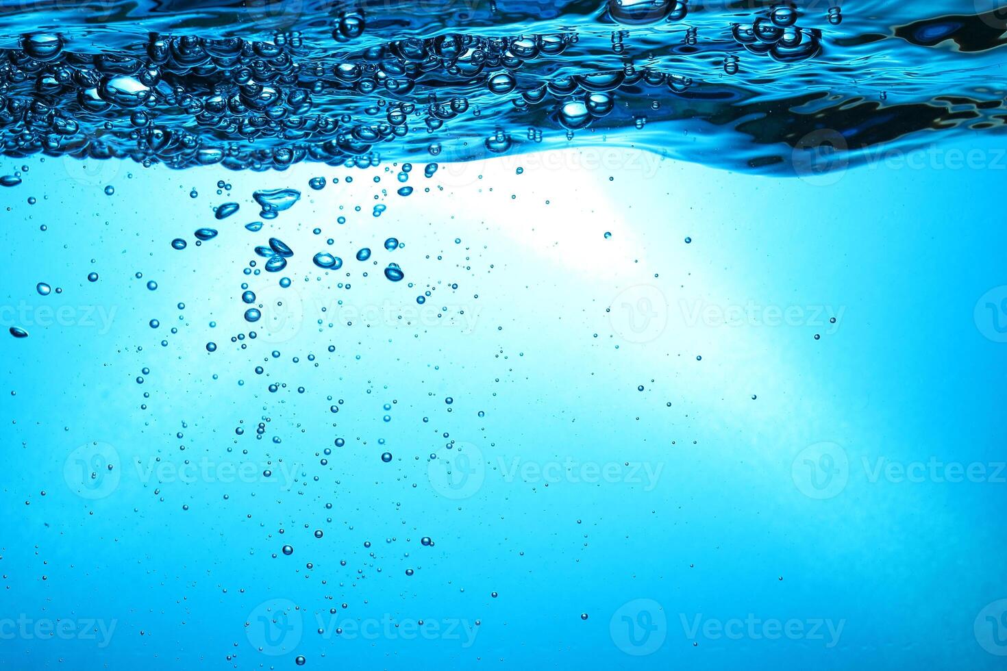 Fresh Water With Underwater Bubbles Texture on a Blue Background Close-up Abstract Liquid Bubbles Aqua Design Wallpaper photo