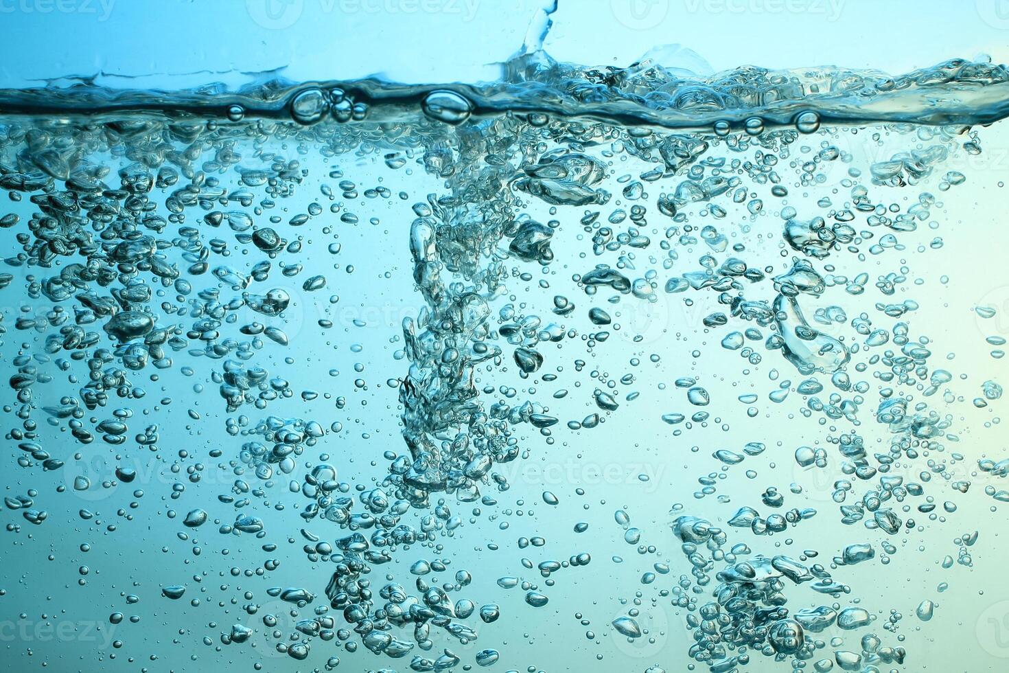 Fresh Water With Underwater Bubbles Texture on a Blue Background Close-up Abstract Liquid Bubbles Aqua Design Wallpaper photo