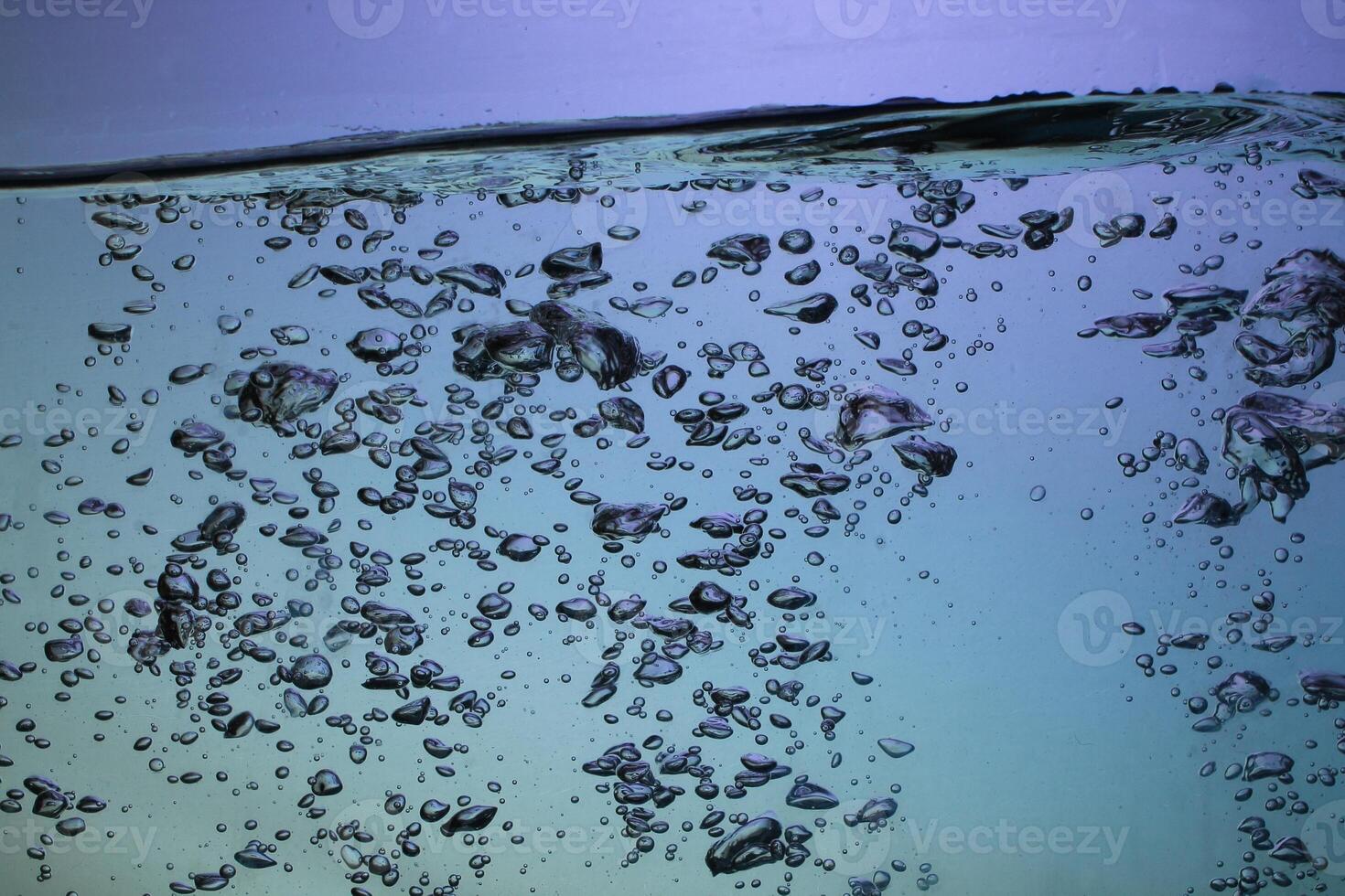 Fresh Water With Underwater Bubbles Texture on a Blue Background Close-up Abstract Liquid Bubbles Aqua Design Wallpaper photo