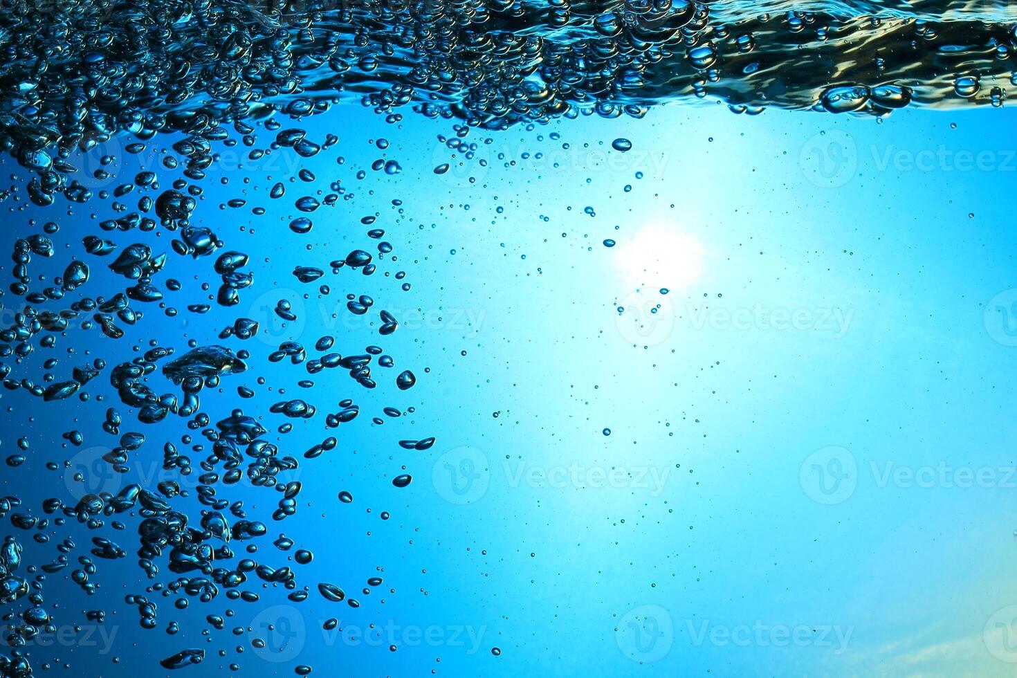 Fresh Water With Underwater Bubbles Texture on a Blue Background Close-up Abstract Liquid Bubbles Aqua Design Wallpaper photo