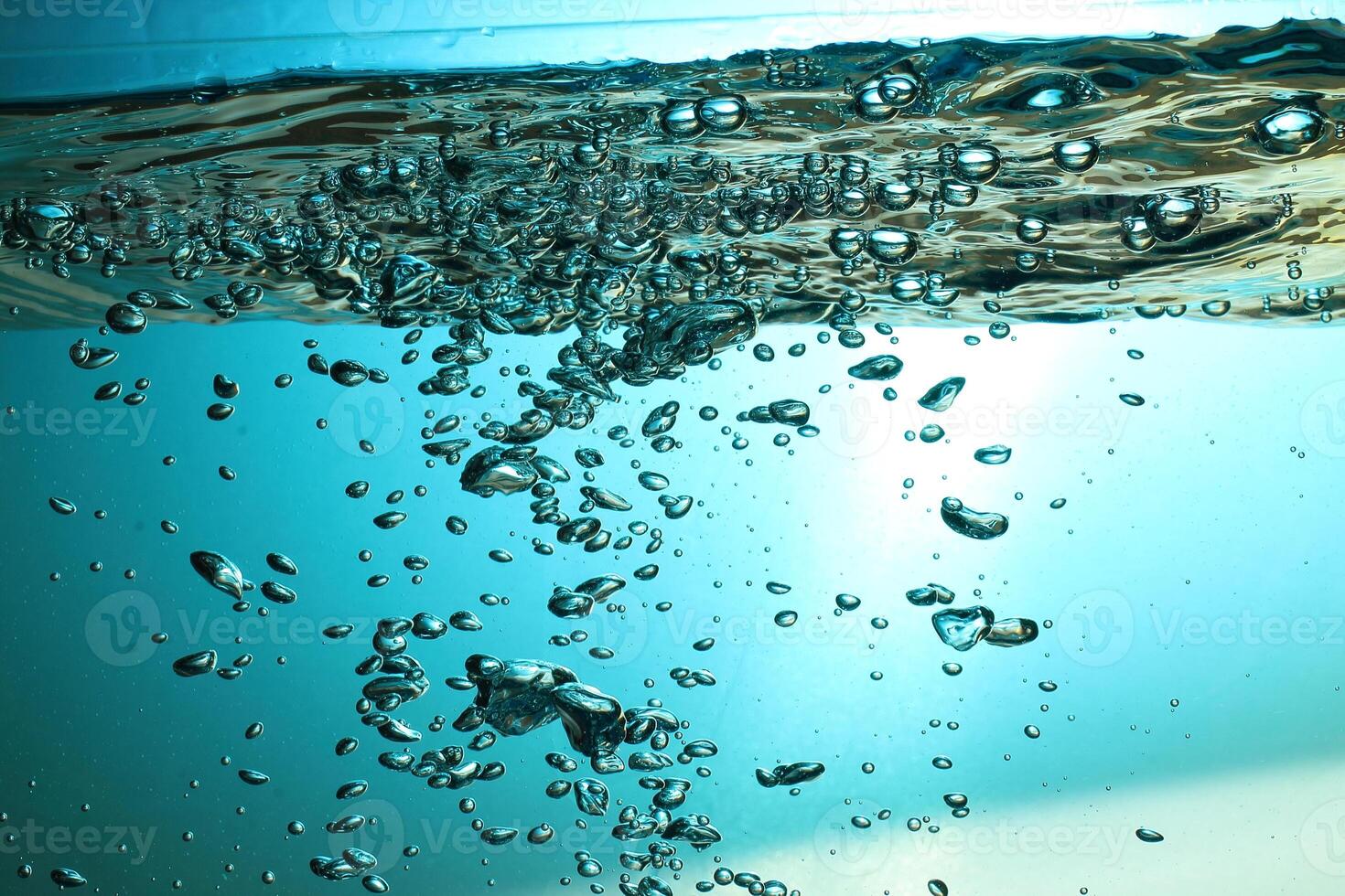 Fresh Water With Underwater Bubbles Texture on a Blue Background Close-up Abstract Liquid Bubbles Aqua Design Wallpaper photo