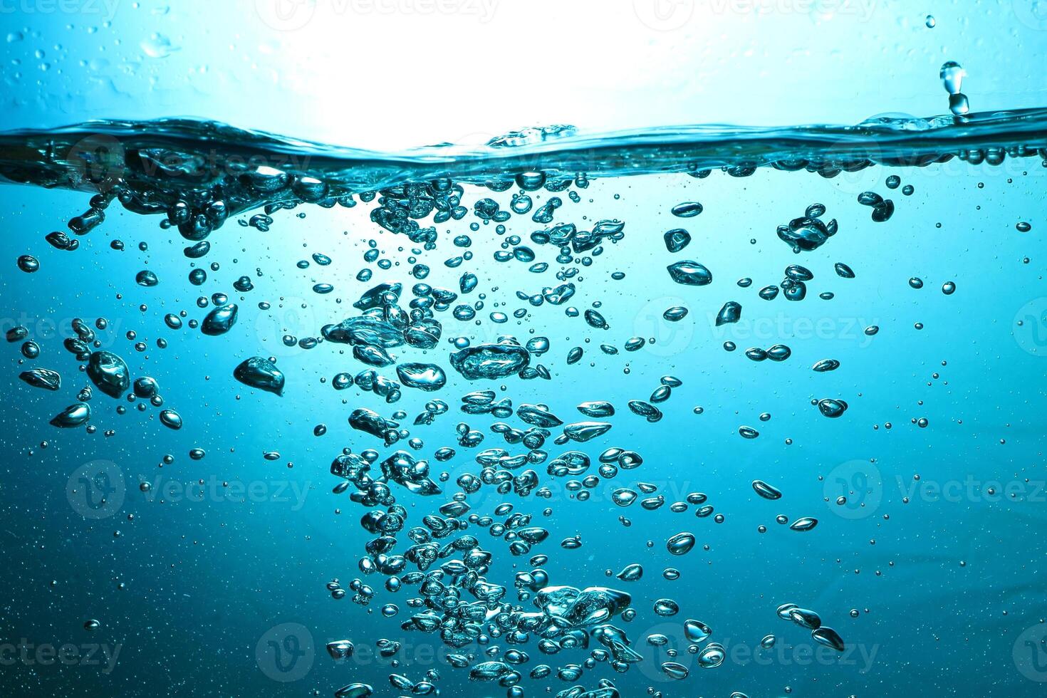 Fresh Water With Underwater Bubbles Texture on a Blue Background Close-up Abstract Liquid Bubbles Aqua Design Wallpaper photo