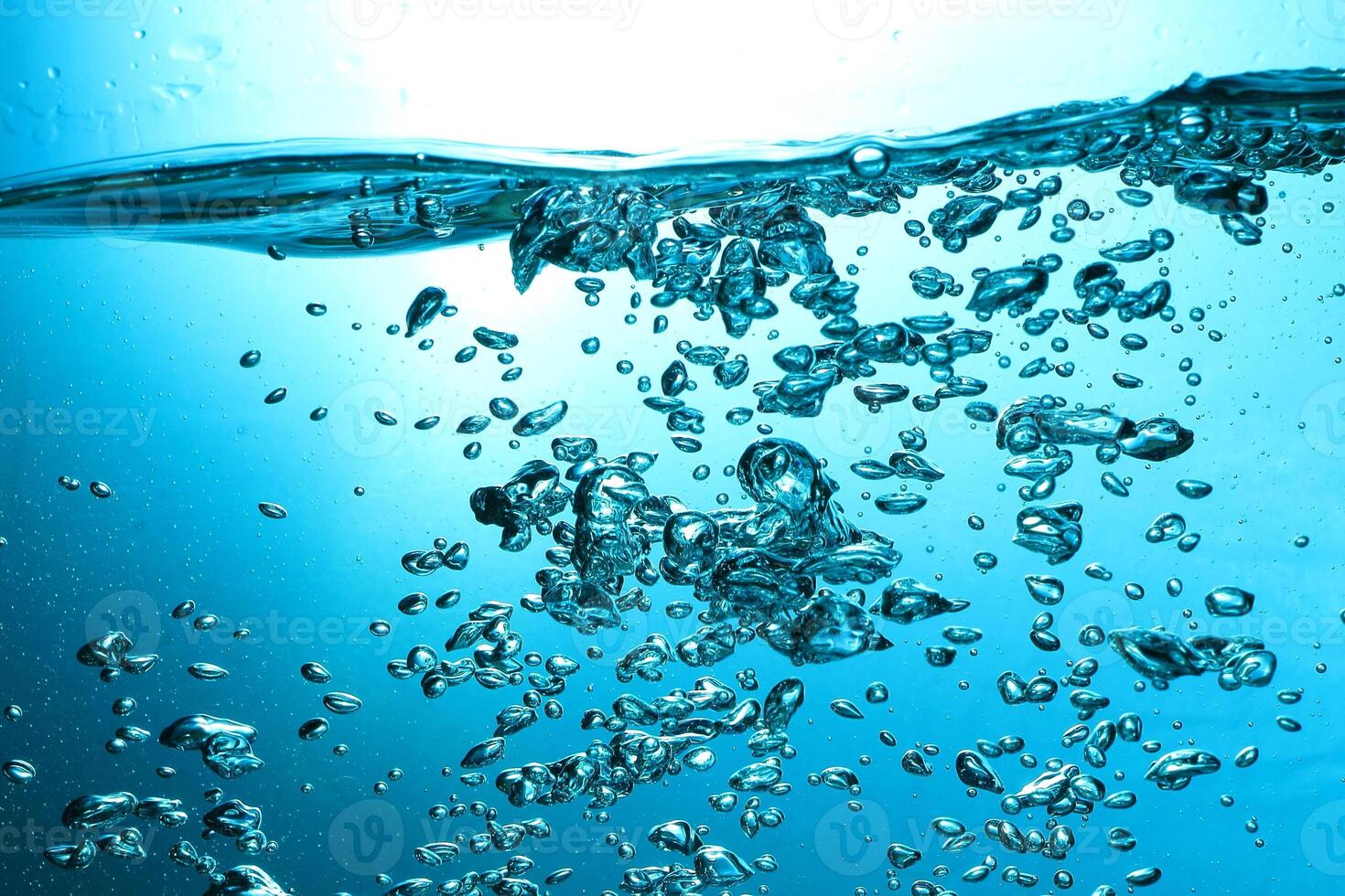 Fresh Water With Underwater Bubbles Texture on a Blue Background Close-up Abstract Liquid Bubbles Aqua Design Wallpaper photo