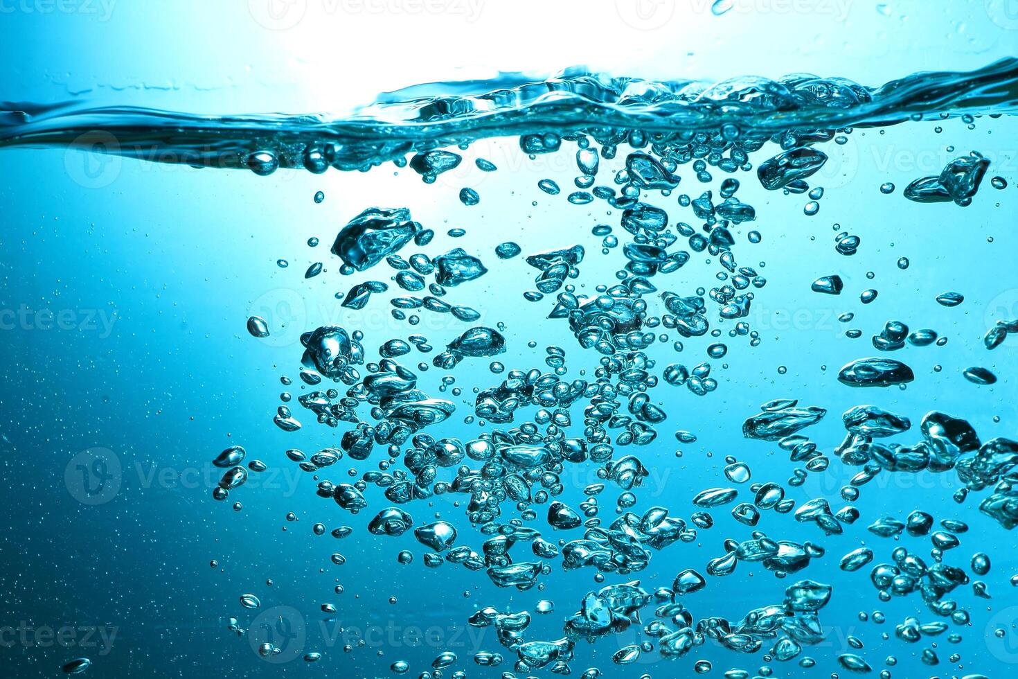 Fresh Water With Underwater Bubbles Texture on a Blue Background Close-up Abstract Liquid Bubbles Aqua Design Wallpaper photo