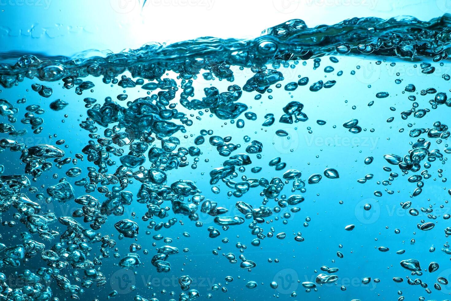 Fresh Water With Underwater Bubbles Texture on a Blue Background Close-up Abstract Liquid Bubbles Aqua Design Wallpaper photo