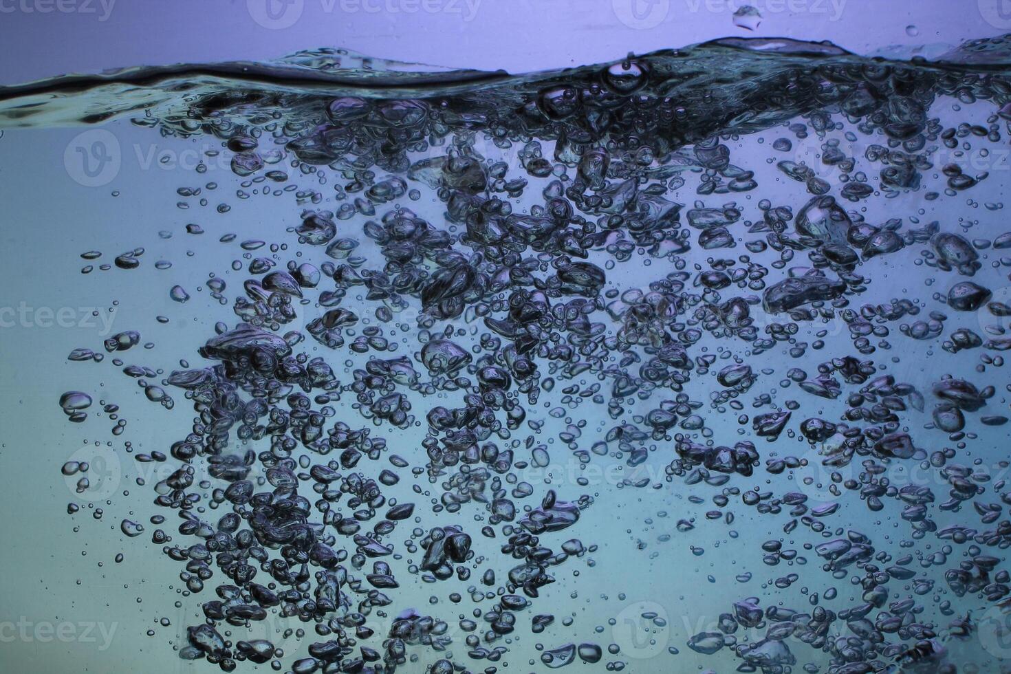 Fresh Water With Underwater Bubbles Texture on a Blue Background Close-up Abstract Liquid Bubbles Aqua Design Wallpaper photo