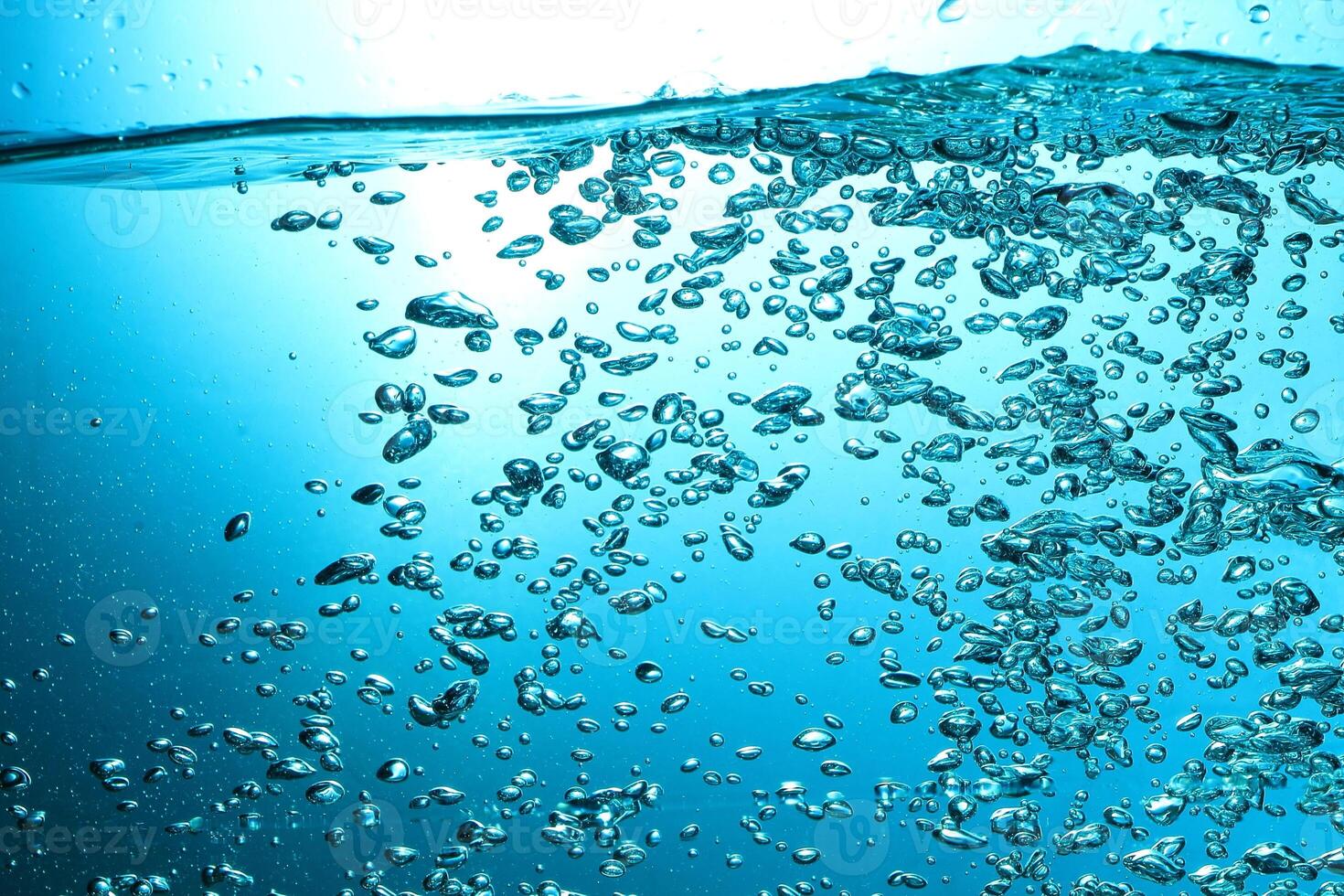 Fresh Water With Underwater Bubbles Texture on a Blue Background Close-up Abstract Liquid Bubbles Aqua Design Wallpaper photo