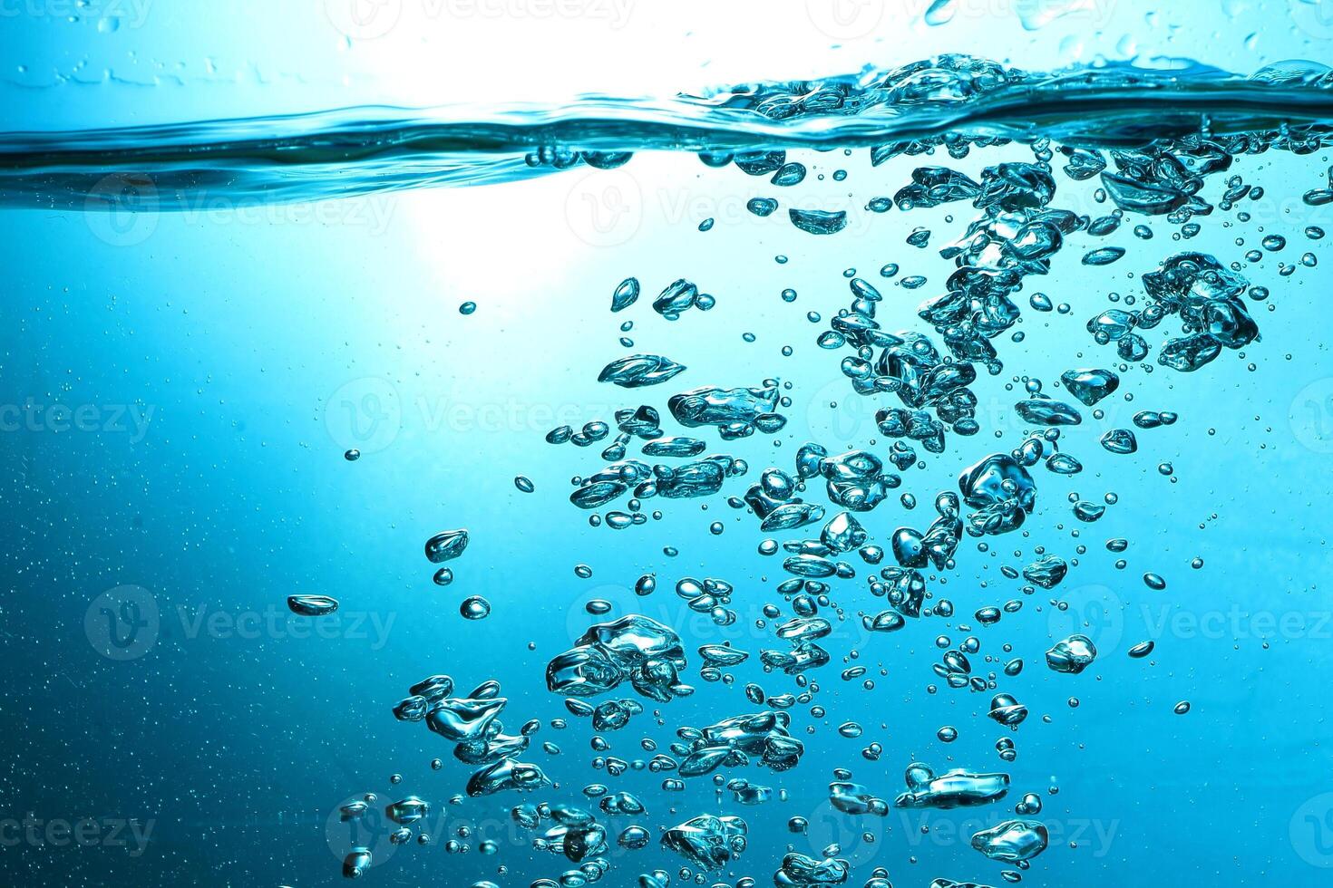 Fresh Water With Underwater Bubbles Texture on a Blue Background Close-up Abstract Liquid Bubbles Aqua Design Wallpaper photo