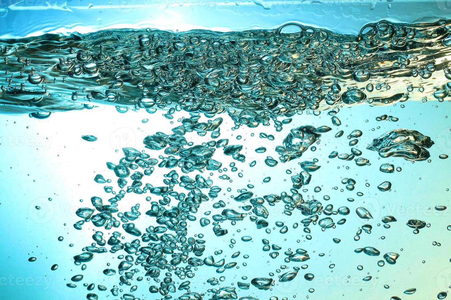 Fresh Water With Underwater Bubbles Texture on a Blue Background Close-up Abstract Liquid Bubbles Aqua Design Wallpaper photo