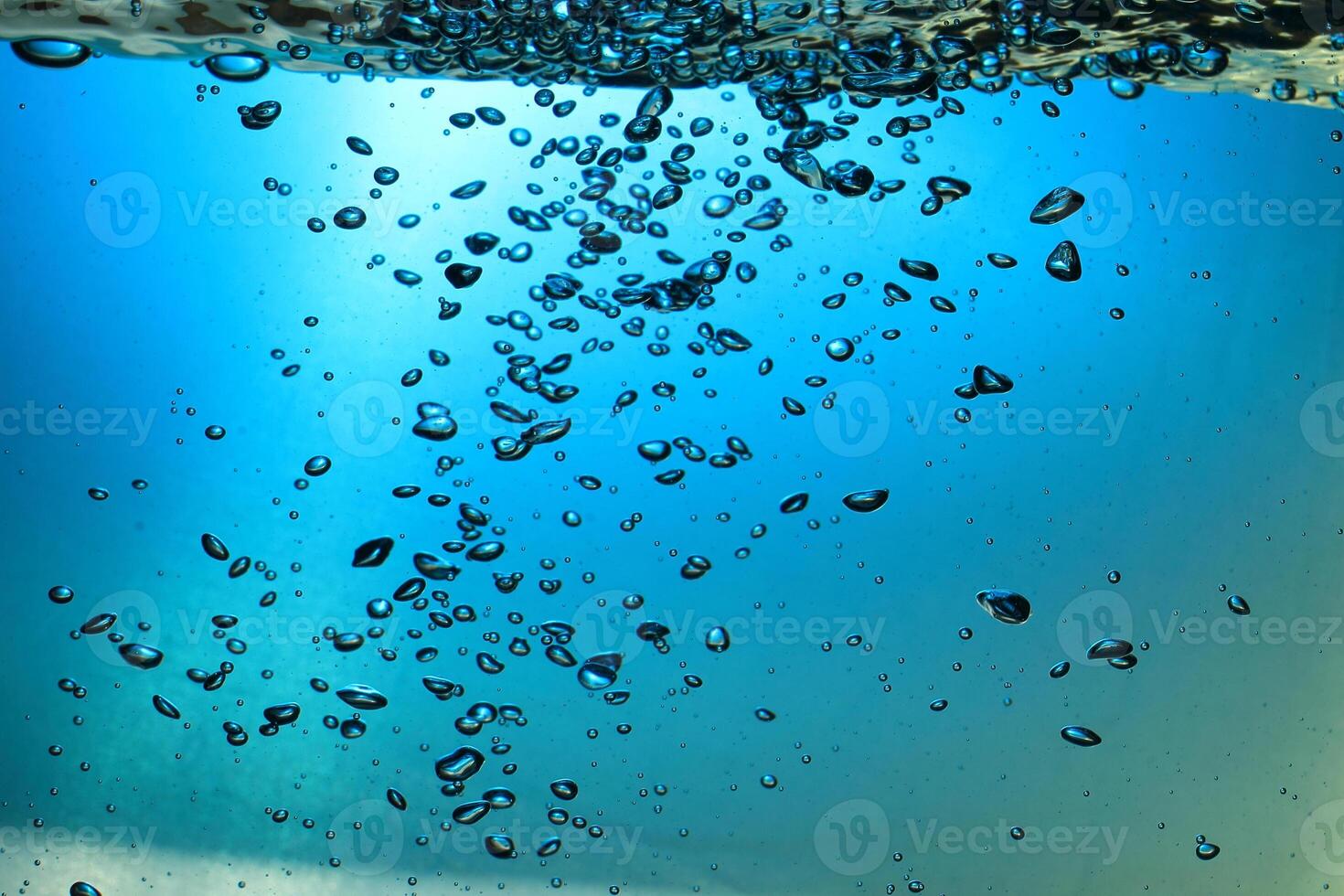 Fresh Water With Underwater Bubbles Texture on a Blue Background Close-up Abstract Liquid Bubbles Aqua Design Wallpaper photo