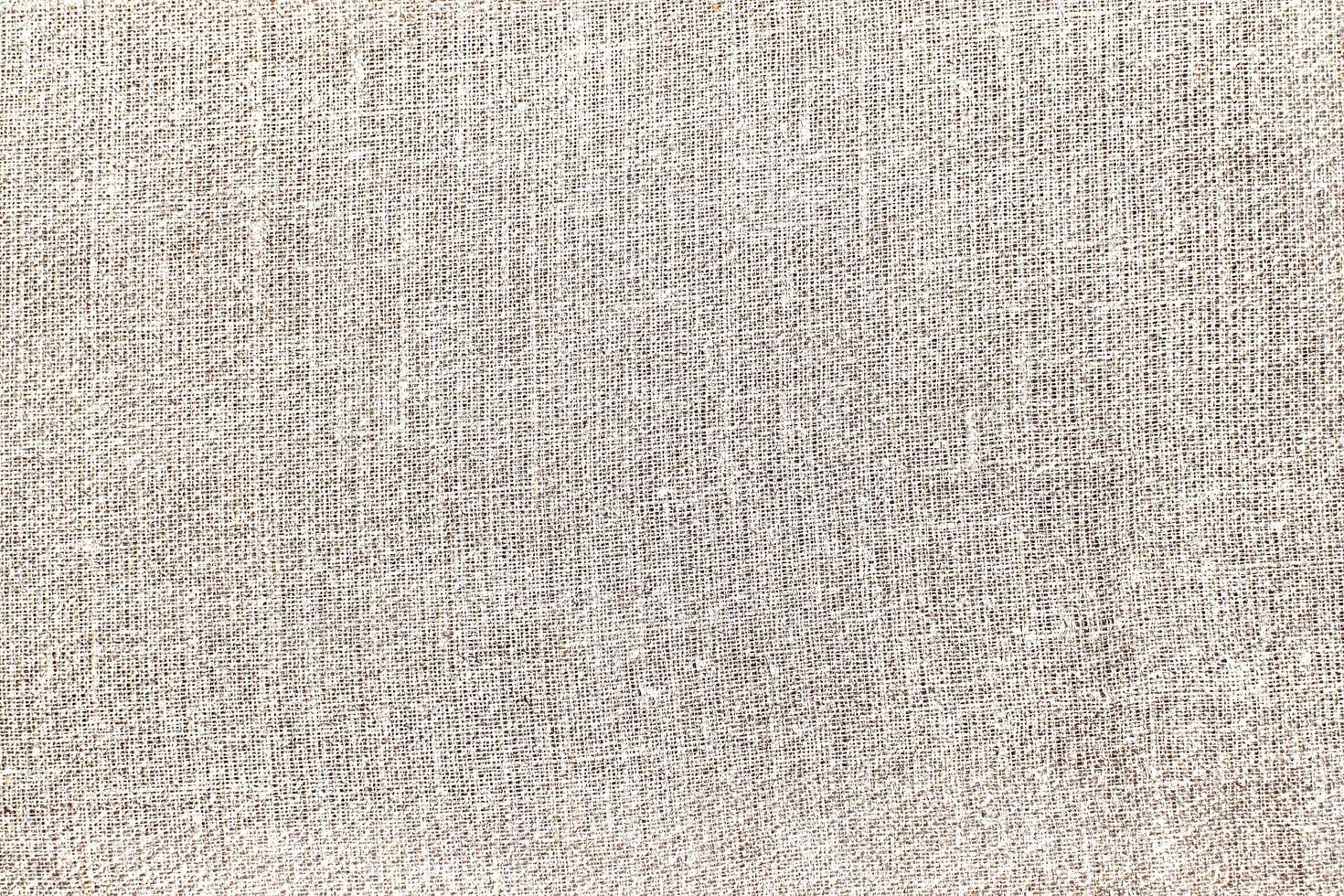 Natural Linen Material Textile Canvas Fabric Texture Background Close-up Detail of Fabric Natural Color Hemp Material Pattern Design Wallpaper. Can be Used as Background or For Graphic Design photo