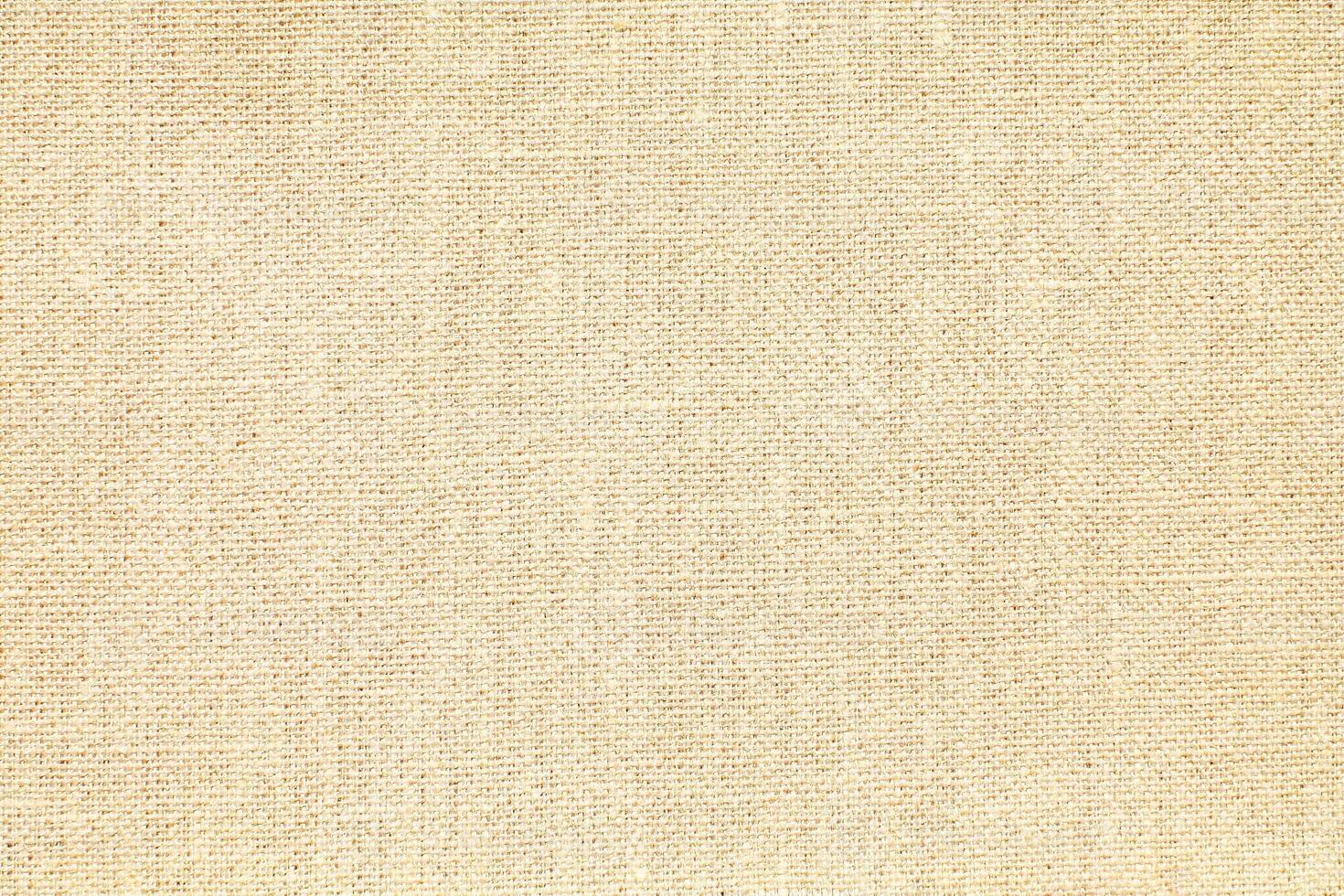 Natural Linen Material Textile Canvas Fabric Texture Background Close-up Detail of Fabric Natural Color Hemp Material Pattern Design Wallpaper. Can be Used as Background or For Graphic Design photo