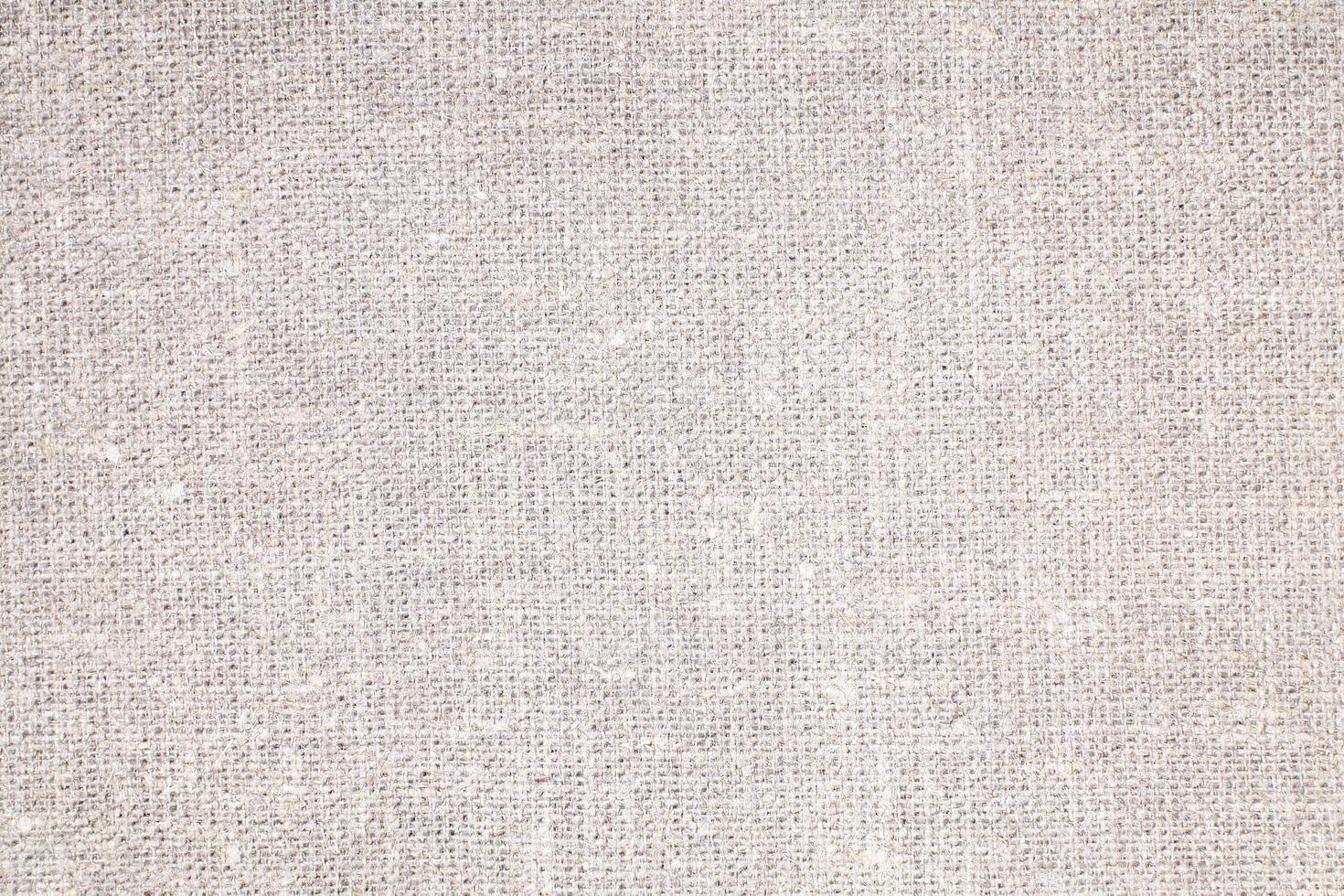 Natural Linen Material Textile Canvas Fabric Texture Background Close-up Detail of Fabric Natural Color Hemp Material Pattern Design Wallpaper. Can be Used as Background or For Graphic Design photo