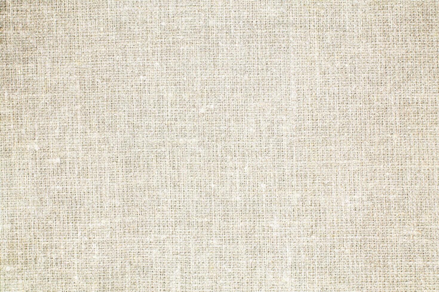 Natural Linen Material Textile Canvas Fabric Texture Background Close-up Detail of Fabric Natural Color Hemp Material Pattern Design Wallpaper. Can be Used as Background or For Graphic Design photo