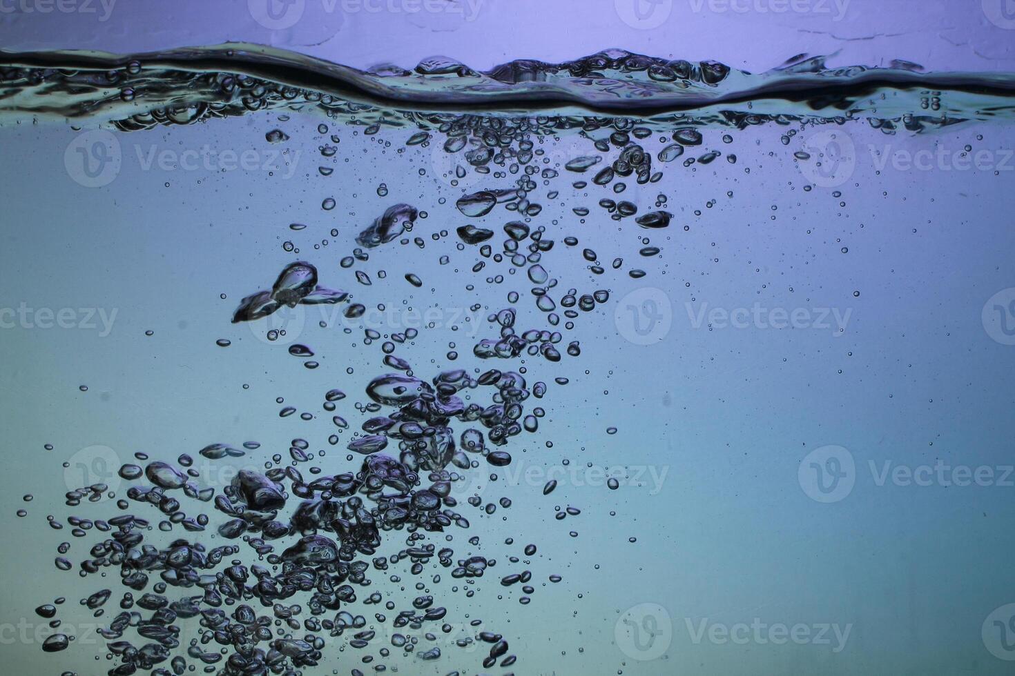 Fresh Water With Underwater Bubbles Texture on a Blue Background Close-up Abstract Liquid Bubbles Aqua Design Wallpaper photo