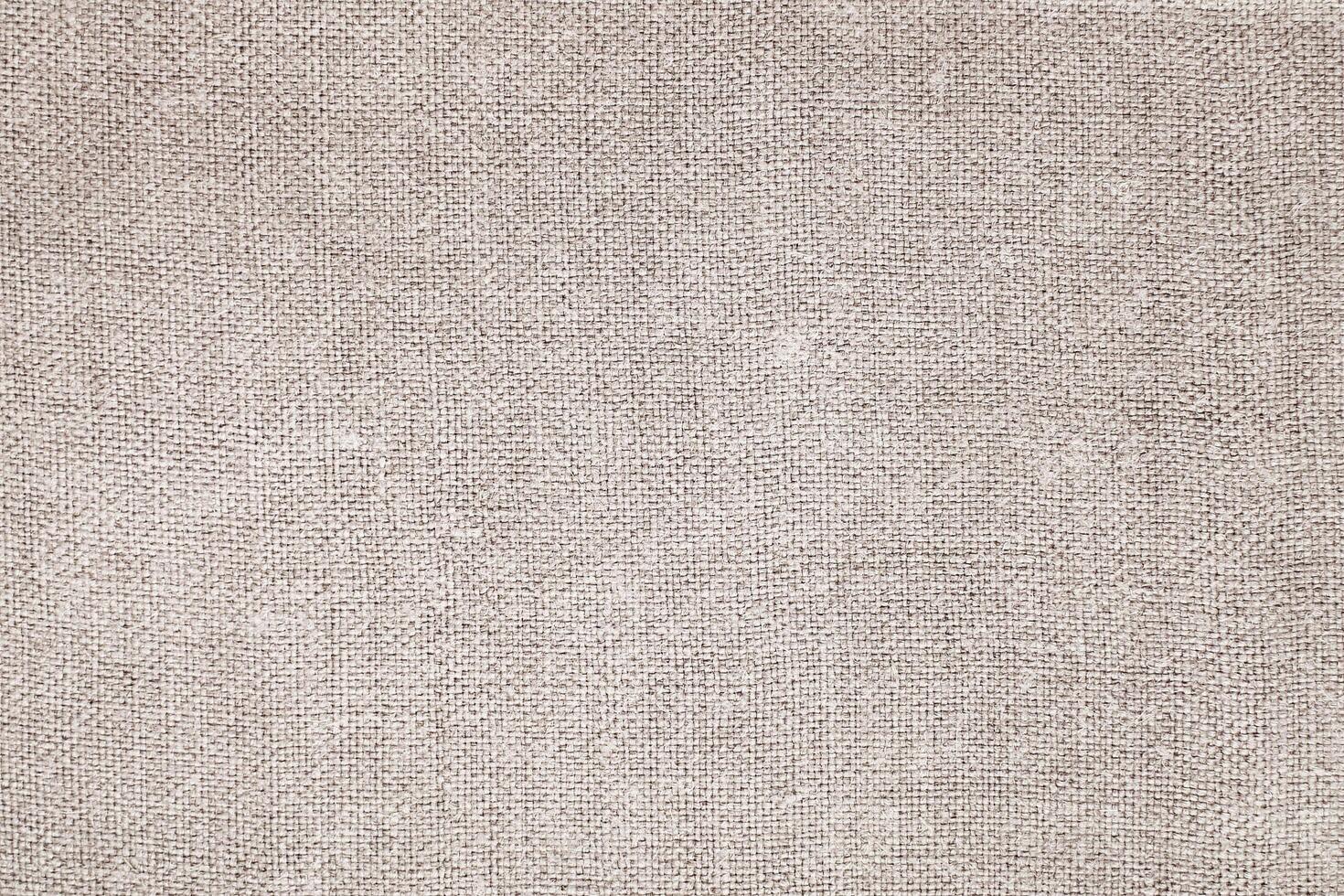Natural Linen Material Textile Canvas Fabric Texture Background Close-up Detail of Fabric Natural Color Hemp Material Pattern Design Wallpaper. Can be Used as Background or For Graphic Design photo
