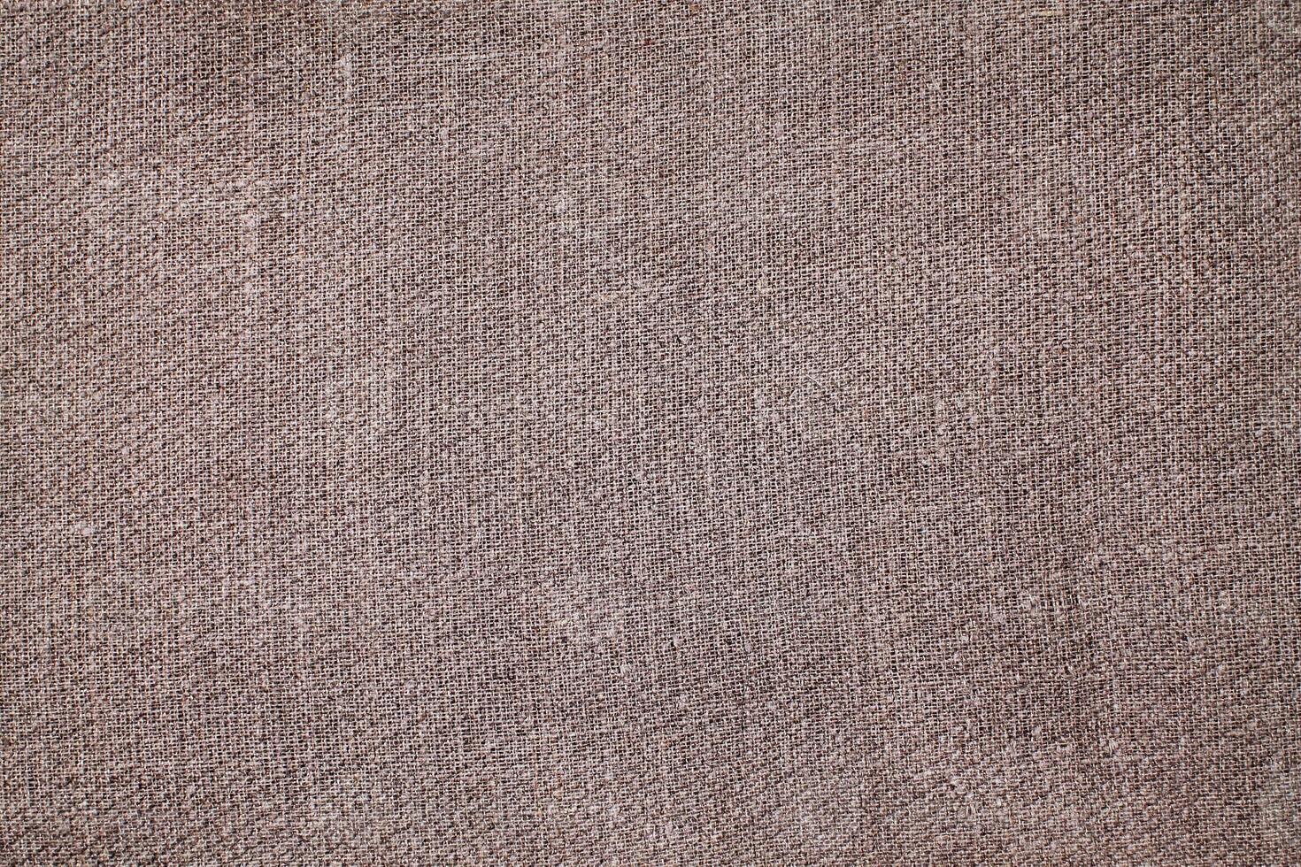Natural Linen Material Textile Canvas Fabric Texture Background Close-up Detail of Fabric Natural Color Hemp Material Pattern Design Wallpaper. Can be Used as Background or For Graphic Design photo
