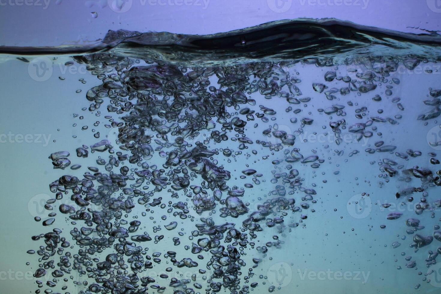 Fresh Water With Underwater Bubbles Texture on a Blue Background Close-up Abstract Liquid Bubbles Aqua Design Wallpaper photo
